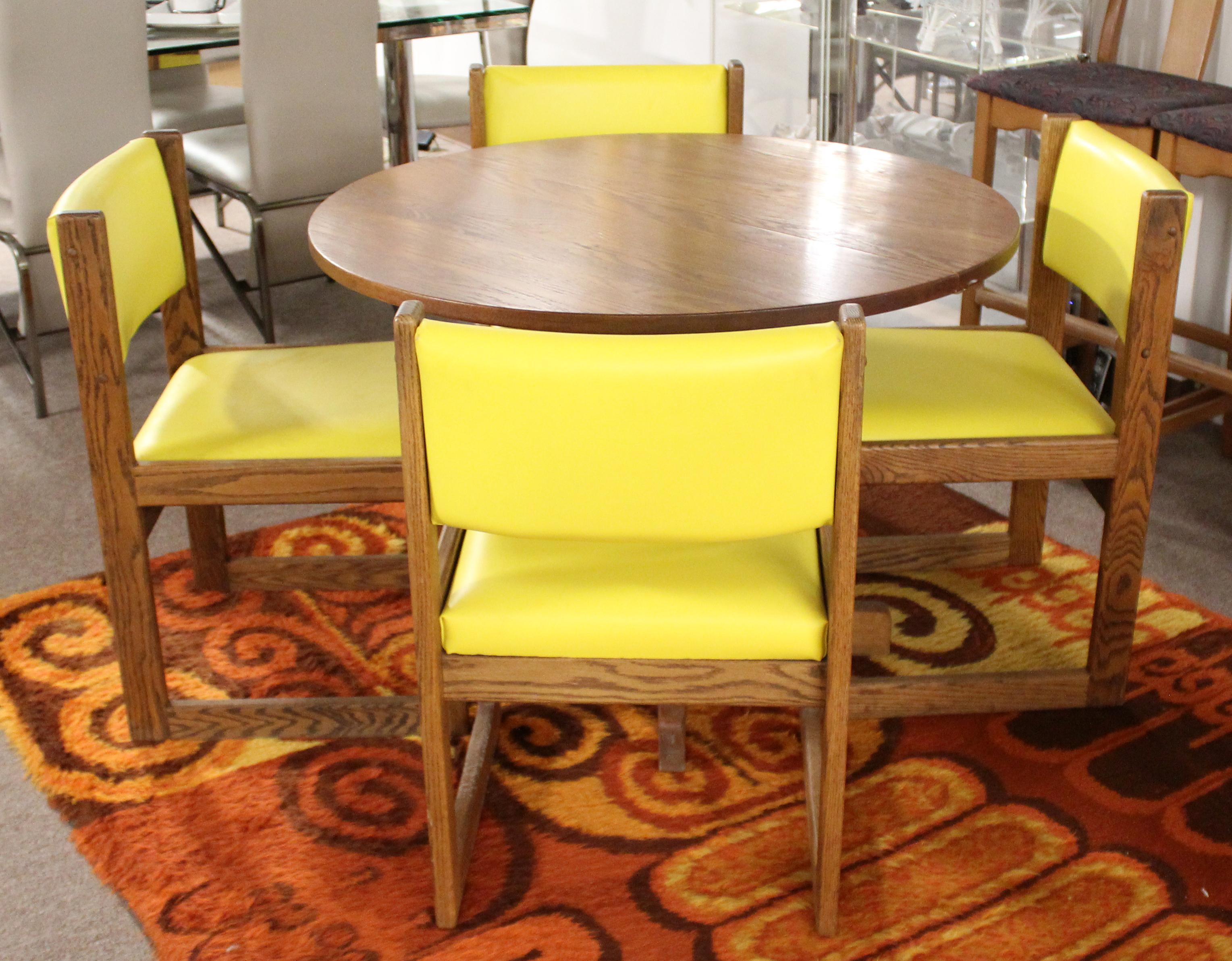 For your consideration is an eye-catching game or dining set, including expandable table and four yellow vinyl covered side dining chairs, by Lakeland Furniture, circa 1960s. In very good vintage condition. The dimensions of the table are 40