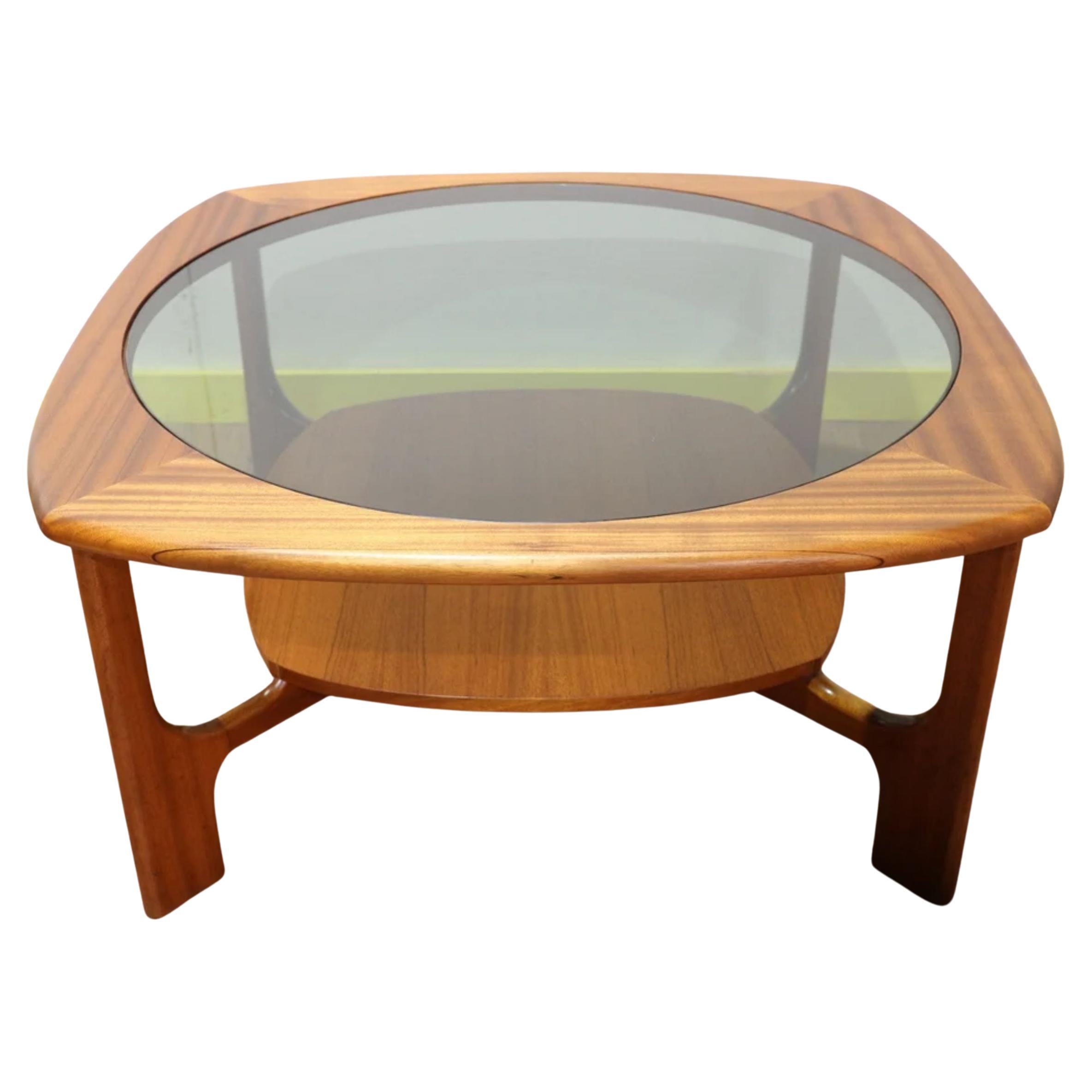 This Stateroom table from Stonehill is a mid century classic, made from solid teak. It features a refined and sculptural base that arches up to elevate a circular top with glass insert. This beautiful retro design is a must have in any modern