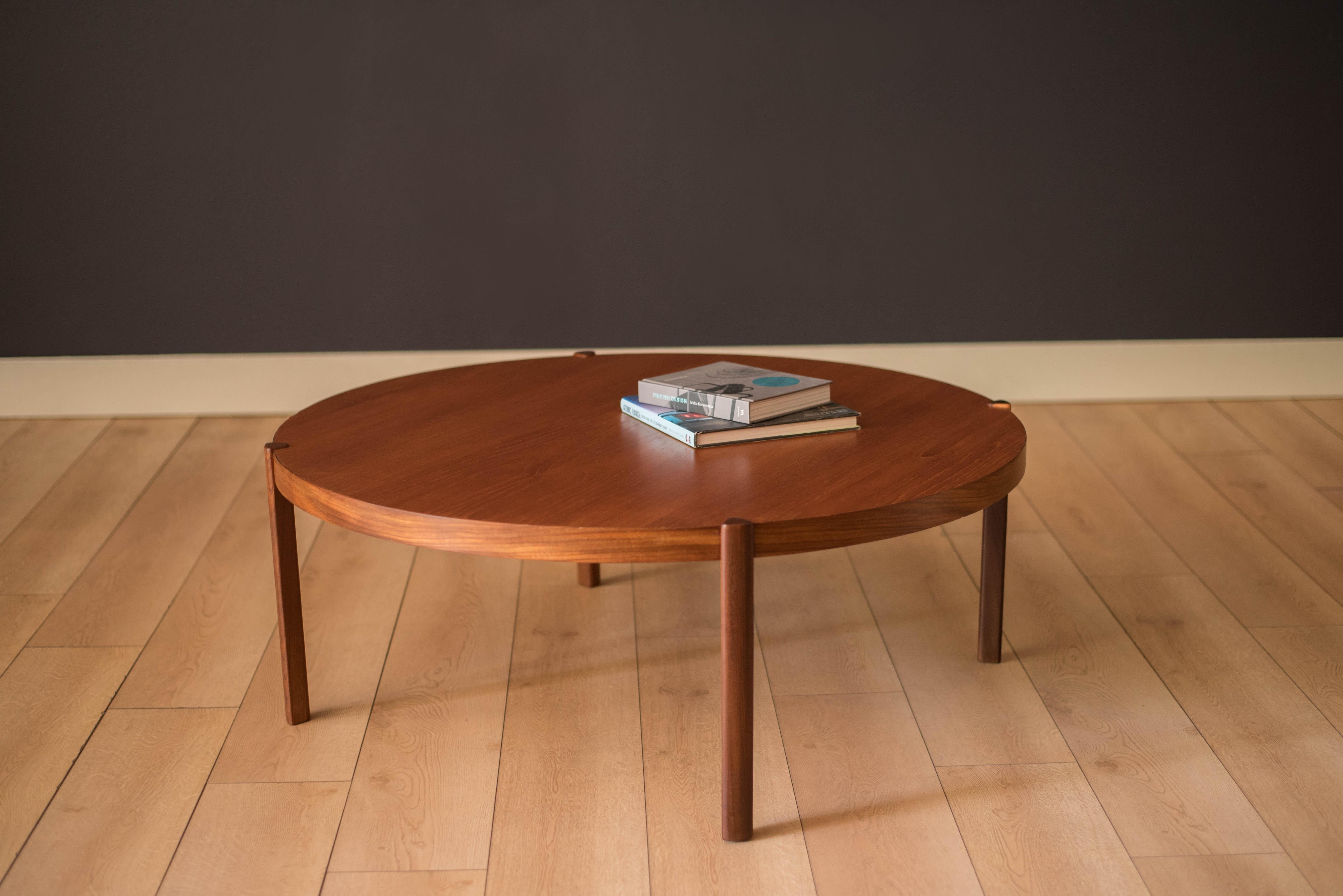 Vintage round coffee table in teak by Hans Olsen, Denmark circa 1960's. This timeless and simple design features warm teak grains that sits at a low profile. Supporting angular legs are crafted in a contasting teak afromasia.