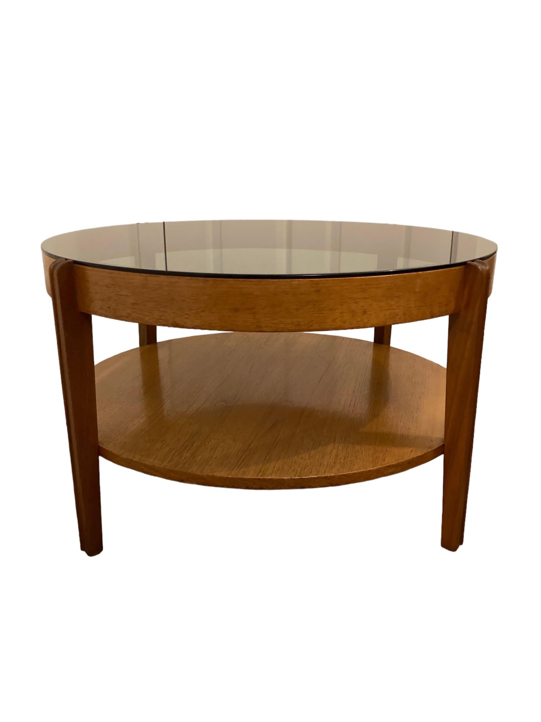 Mid Century Modern round Teak Coffee Table, smoked glass by Remploy of England. Classic 1960's design, stylish tapered legs with bottom shelf. Highly original.
H: 47 cm
Diameter/Width : 77 cm