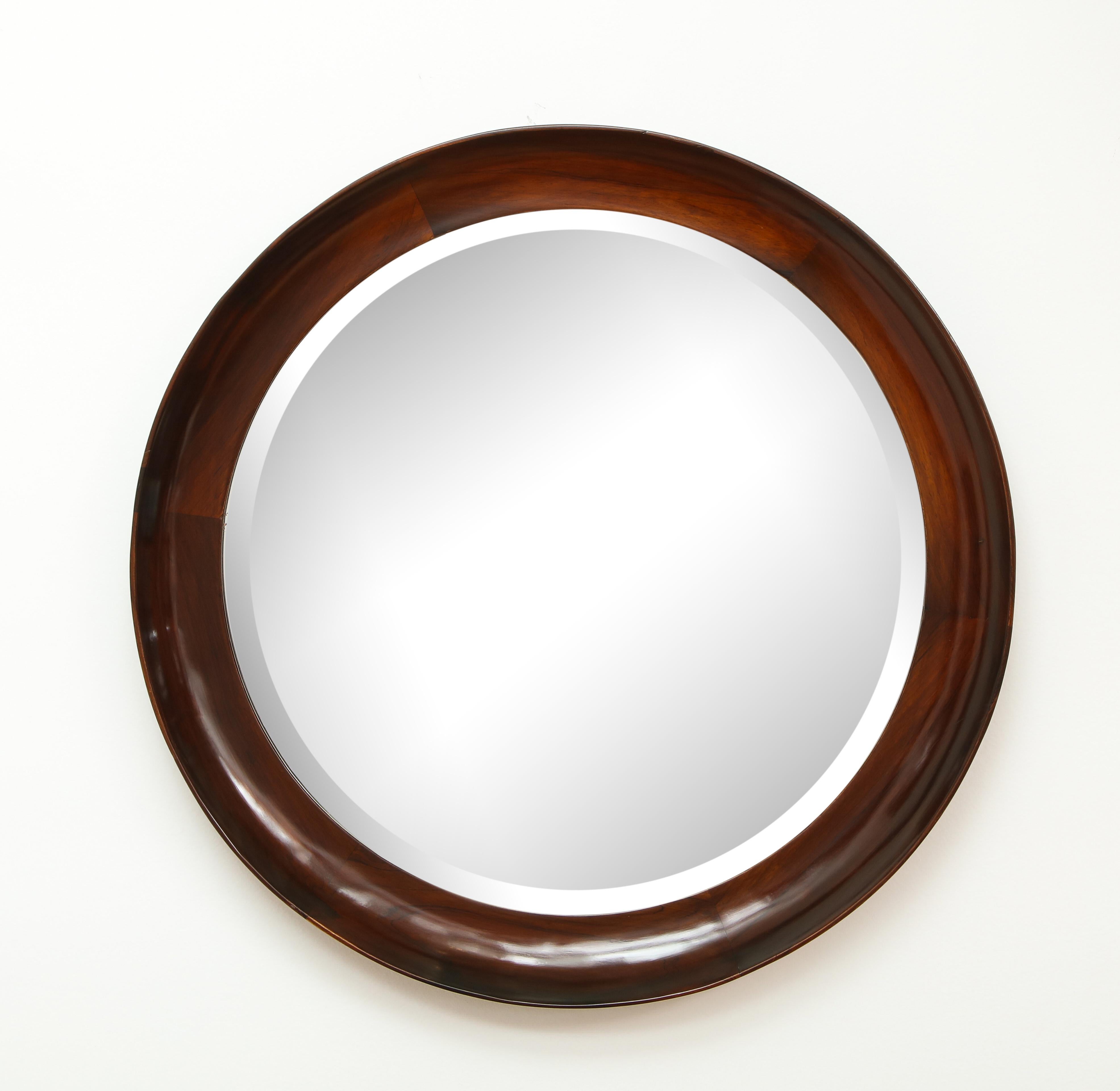 Mid-Century Modern Round Wall Mirror in Wood Frame by OCA, Brazil, 1960s

This vintage wall mirror was manufactured circa 1960s in Brazil. It features an elegant round frame in solid wood, finished in natural varnish maintaining the wood's real