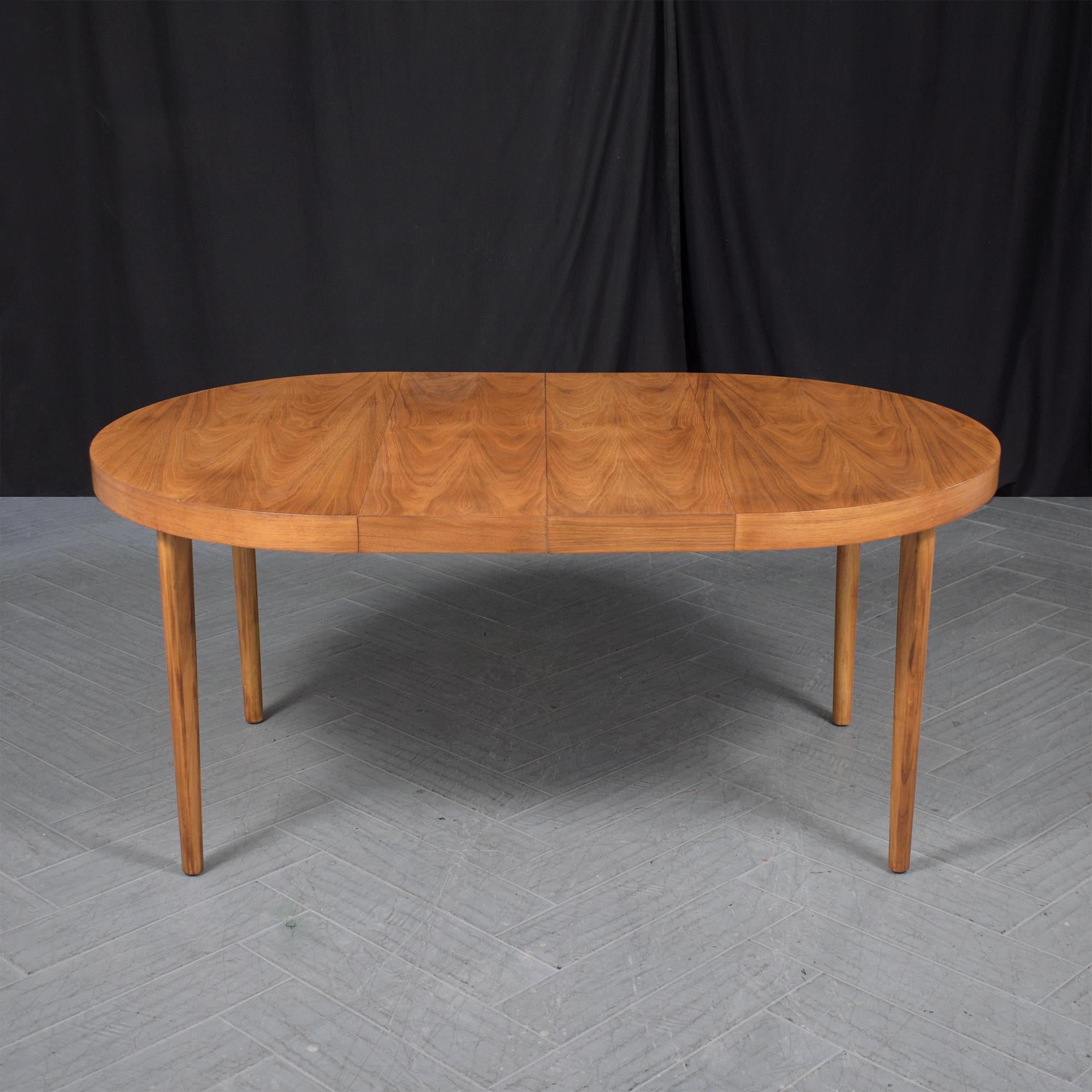 Experience the elegance of the mid-century era with our meticulously restored dining table. This striking round dining table, crafted from top-grade walnut wood, showcases the artistry of its time. It has been brought back to its original glory by