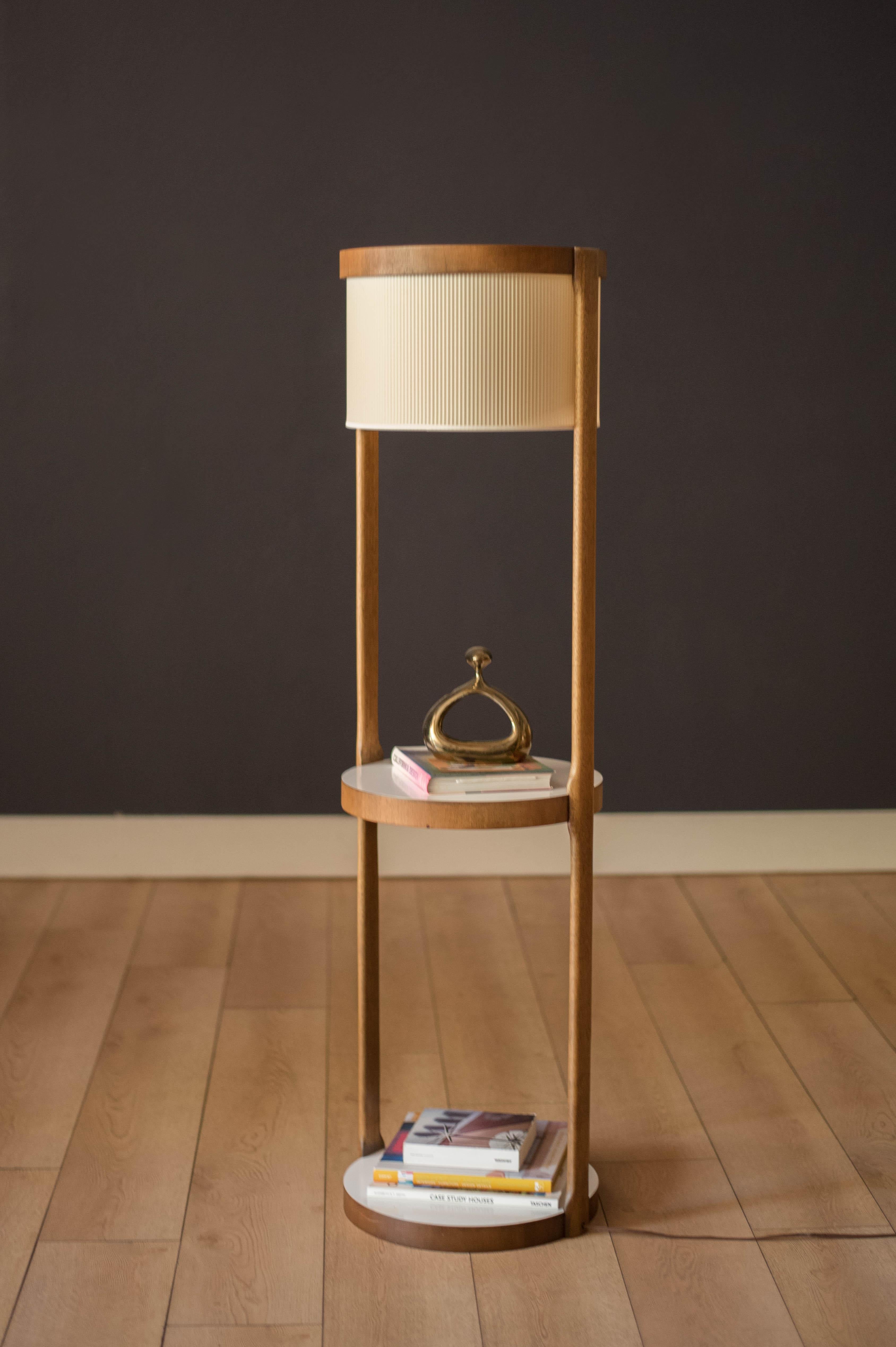 Vintage floor lamp in walnut by Modeline Lamp Company, circa 1960s. This unique piece features a sculptural walnut base with two contrasting white laminate end tables for easy maintenance. Includes the original parallel styrene drum shade and