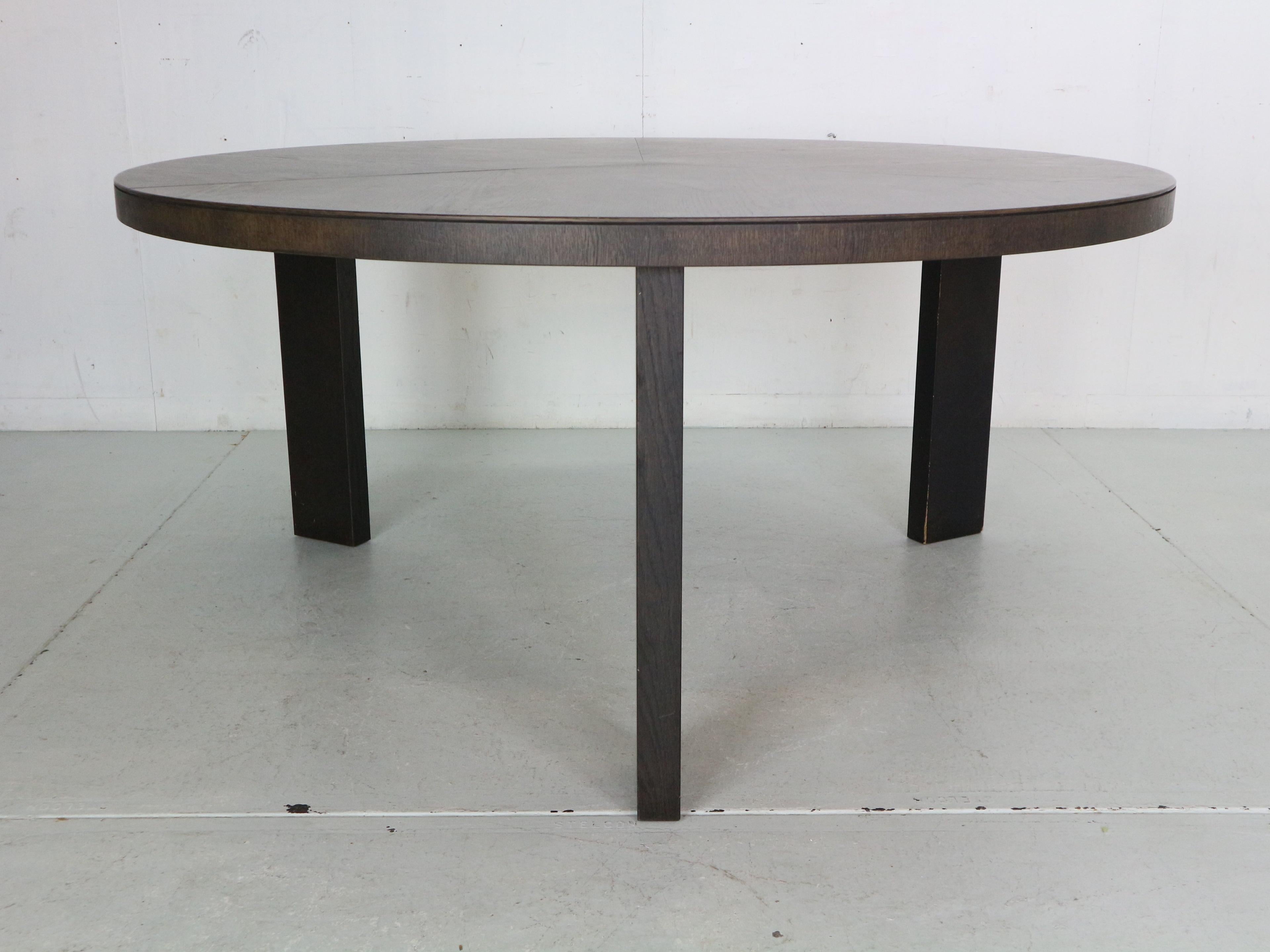 Mid- Century Modern period round dinning table, made around 1980's period, Italy.

Massive round table with beautiful triangle shaped leave.
Made of wenge processed wood.
Original, very good condition.
The legs can be taken apart for a