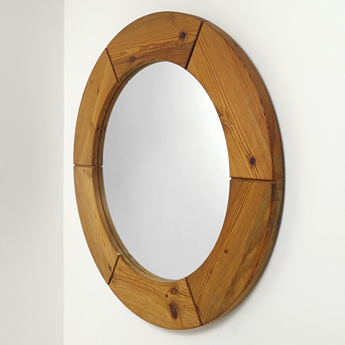This Swedish mirror has a diameter of 100 cm / 39.4 inch and has a frame made of pine wood that is divided into six sections. 
It was made in the 1950s by Glasmäster Markaryd.