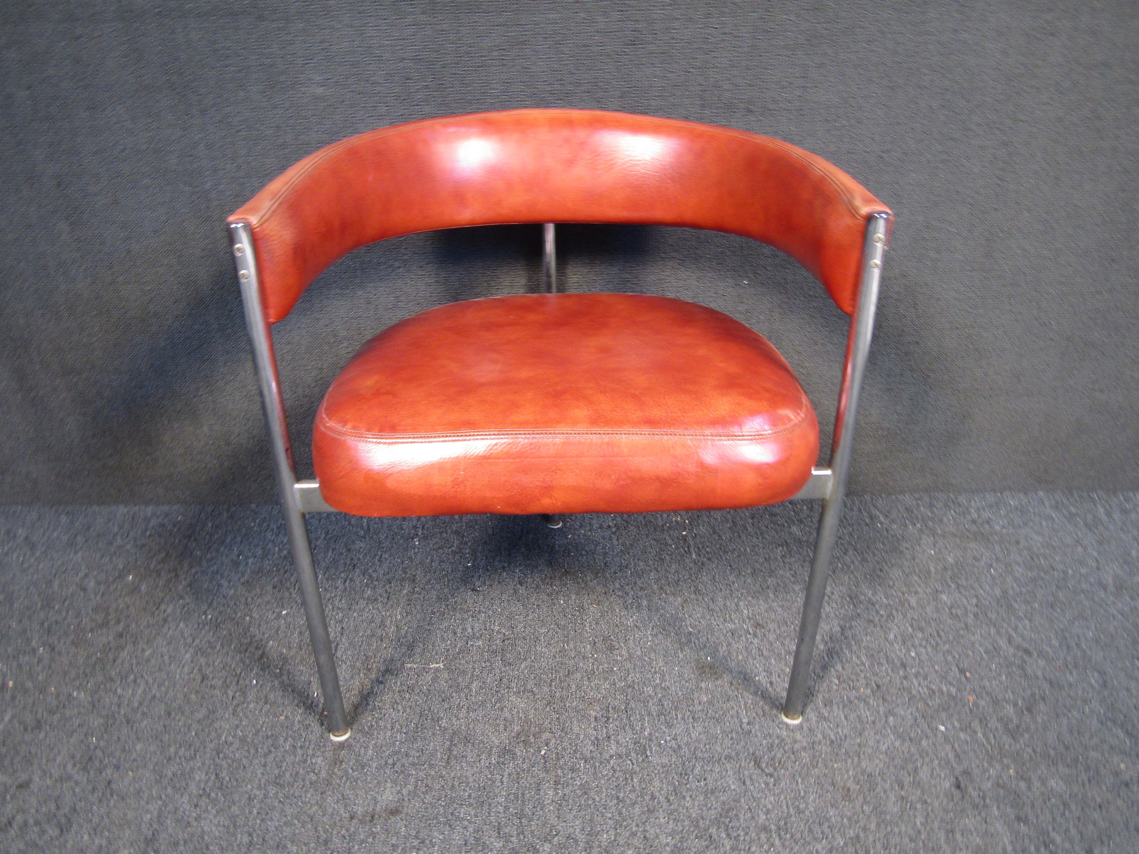 With a rounded back, three legs, and rich leather upholstery, this vintage roundback chair is perfect for adding mid-century style to any space. Please confirm item location with seller (NY/NJ).