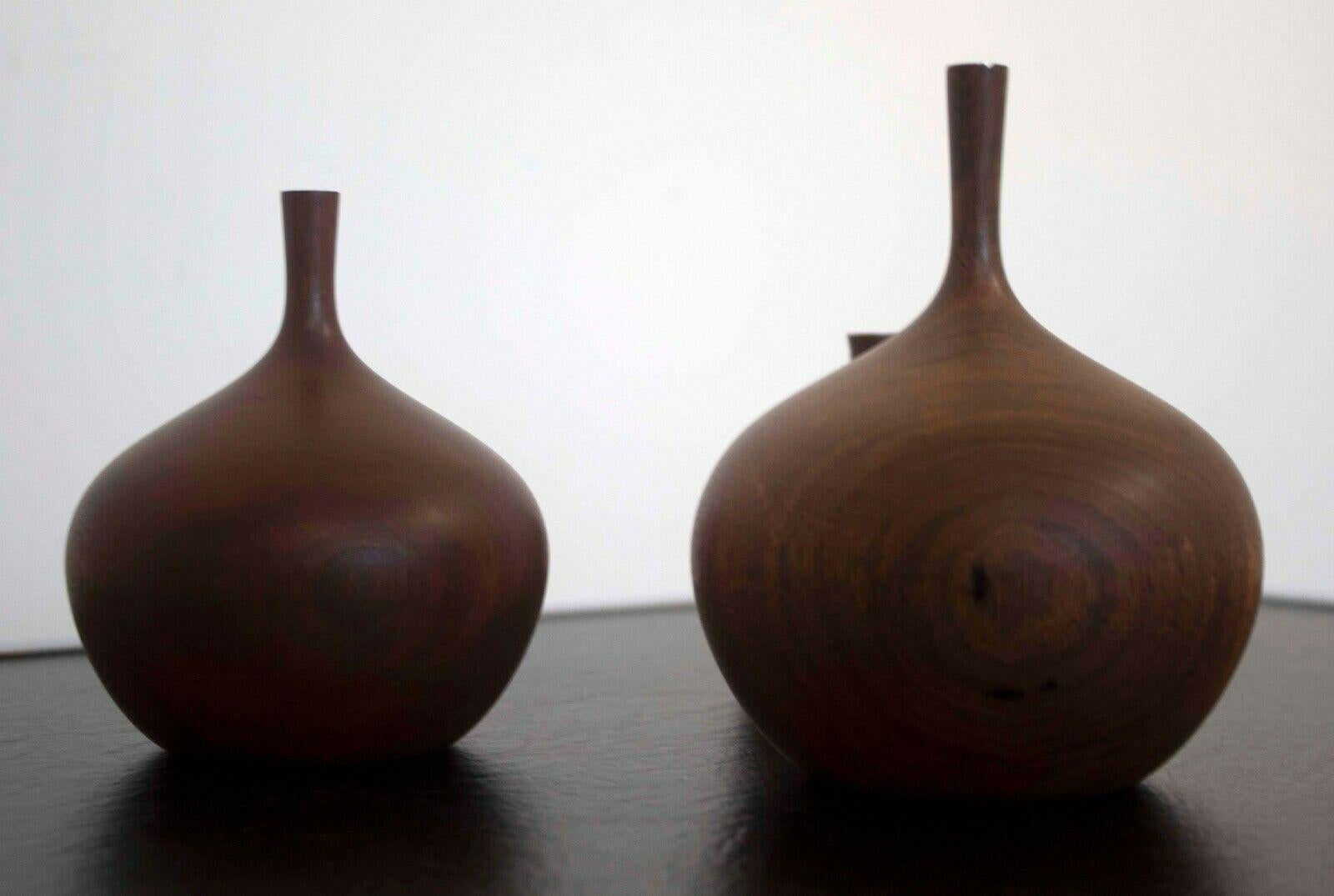 Le Shoppe Too in Michigan is stunning set of 3 carved walnut wood vessels signed by Osolnik Originals. Dimensions: 5.75h x 4.5 dia / 5h x 4 dia / 3.75h x 3 dia. In excellent vintage condition. Rude Osolnik considered to be one of the fathers of