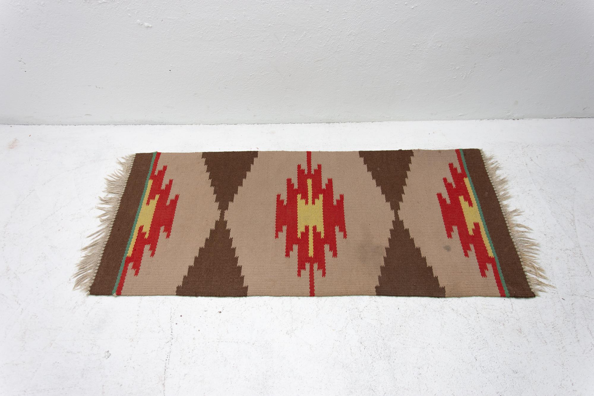 Mid-Century Modern rug Kelim. Made in the 1960s. It's associated with EXPO 58, handmade work, simple design.

Signs of age and using, slight abrasions at one point, the rug fringe are not complete, in one place a small stain, see photos.