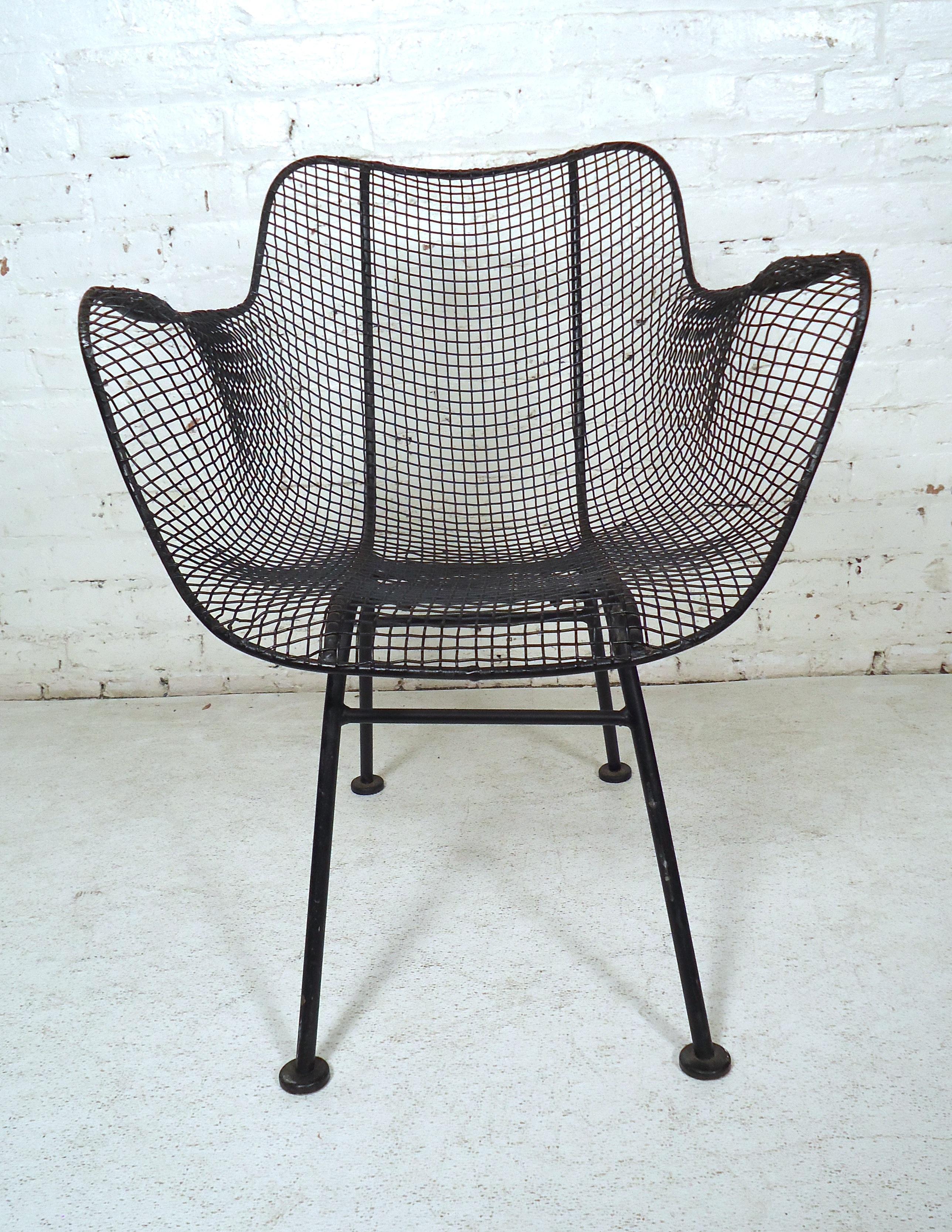 Great indoor or outdoor wire chair by American designer Russel Woodard for his Sculptura line. Tightly woven wrought iron gives a strong, long lasting chair, which is also extremely comfortable. 

(Please confirm item location - NY or NJ - with