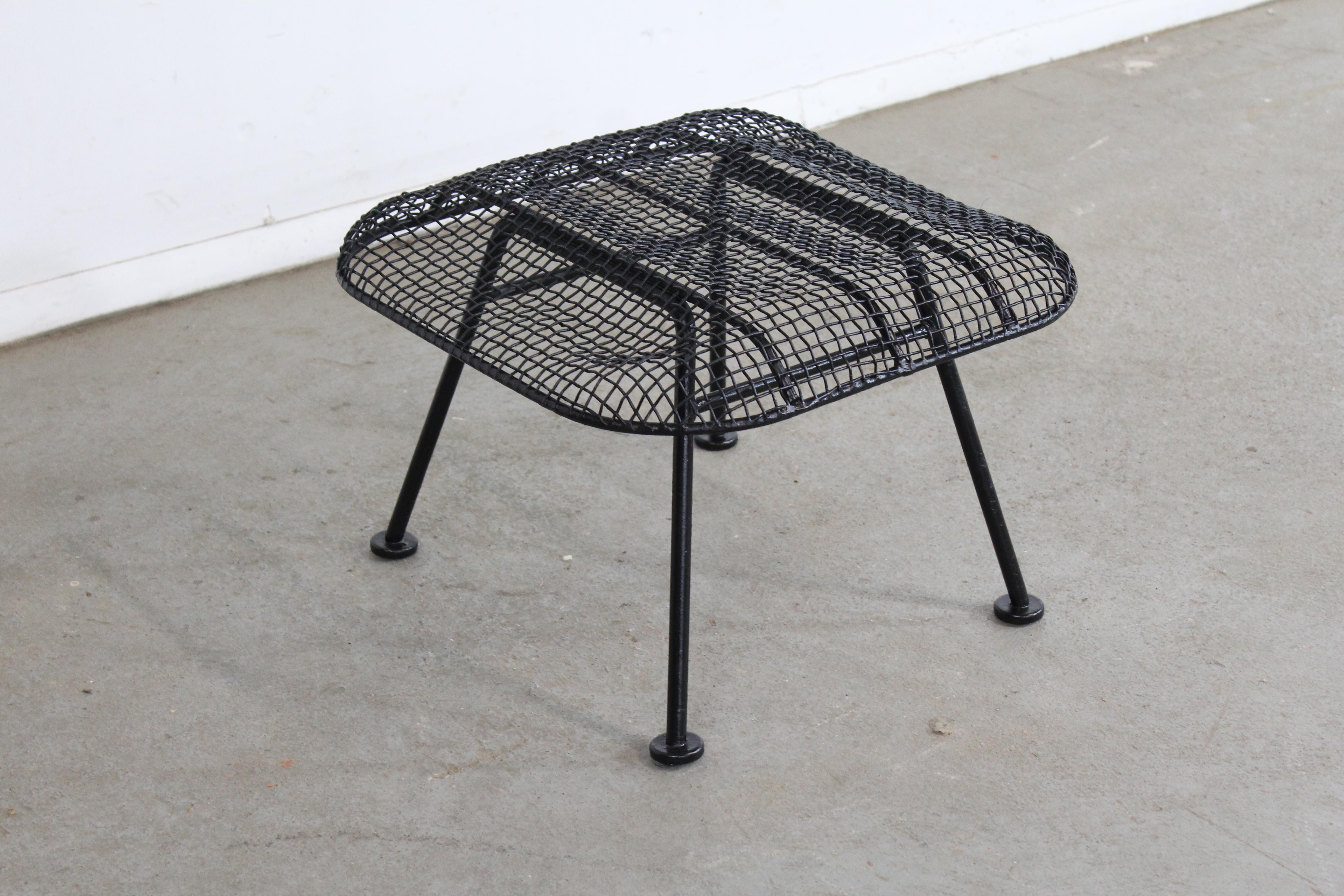 Mid-Century Modern Russell Woodard sculptura outdoor wrought iron ottoman/stool

Offered is a vintage outdoor ottoman by Russell Woodard 'Sculptura'. It has a wrought-iron frame with a low-slung woven mesh steel seat made to withstand all weather