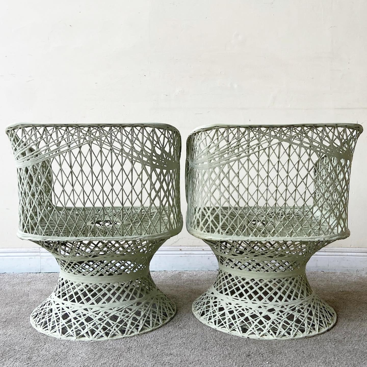 Incredible pair of Mid-Century Modern spun fiberglass arm chairs. Each feature a fantastic woven design with a painted green finish.