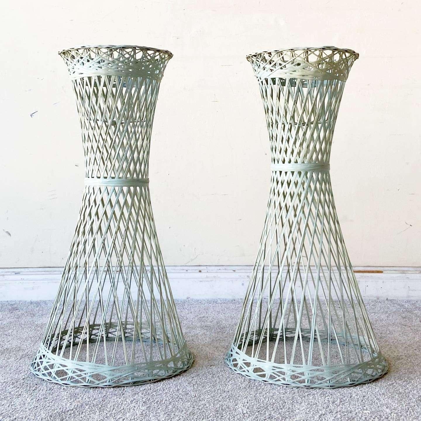 Excellent pair of mid century modern Russell Woodard spun fiber glass plant stands. Displays a tantalizing hourglass shape with a minty green finish.
