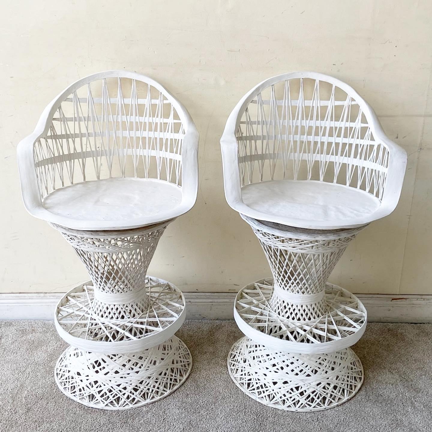 Exceptional set of 4 Mid-Century Modern spun fiberglass Russell Woodard stools. Each feature a woven frame with a white finish and swivel top.