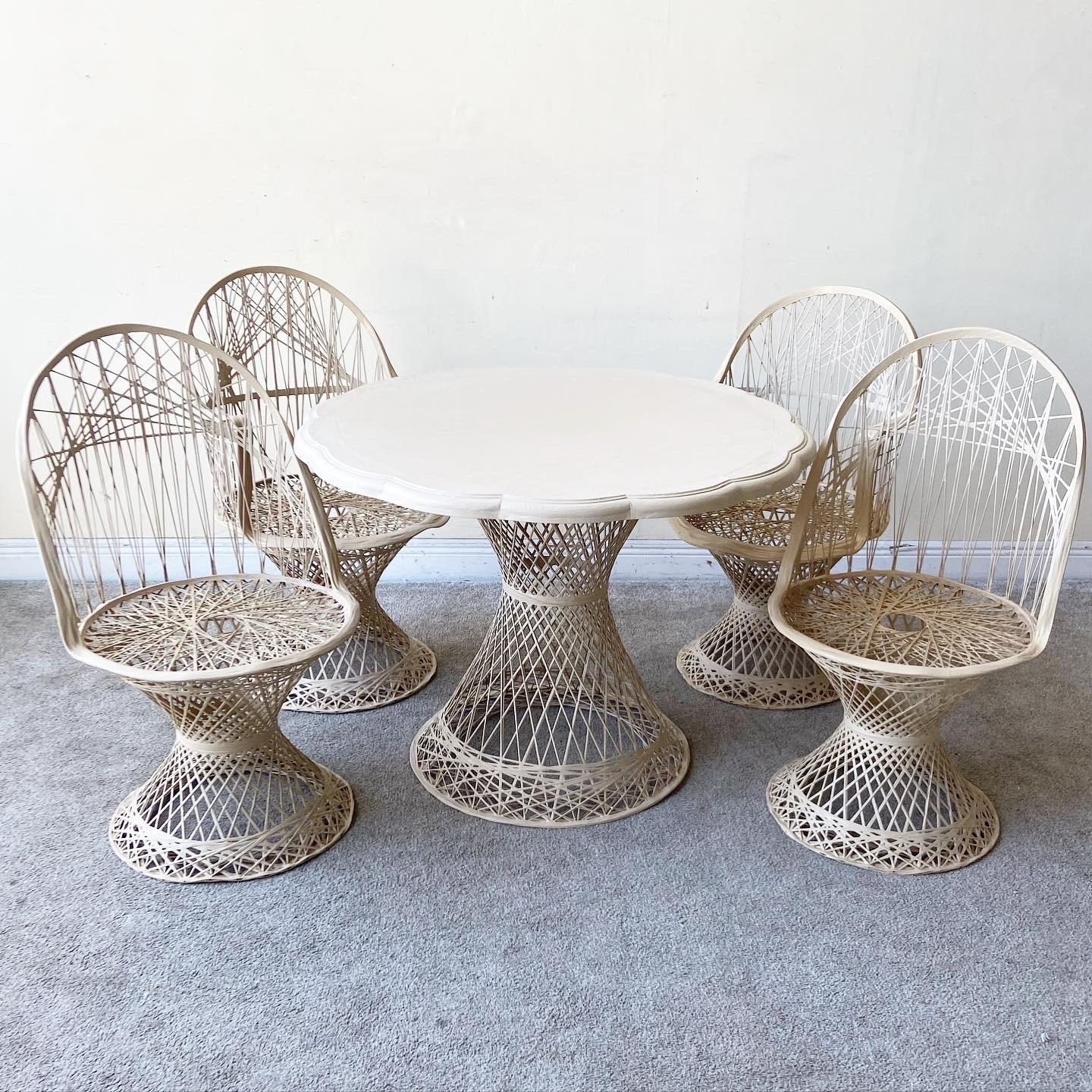 Incredible Mid-Century Modern Russell Woodard spun fiberglass dining set. Features two arm chairs and two side chairs with a matching dining table.

Table measures 40.5” D, 29.5” H.