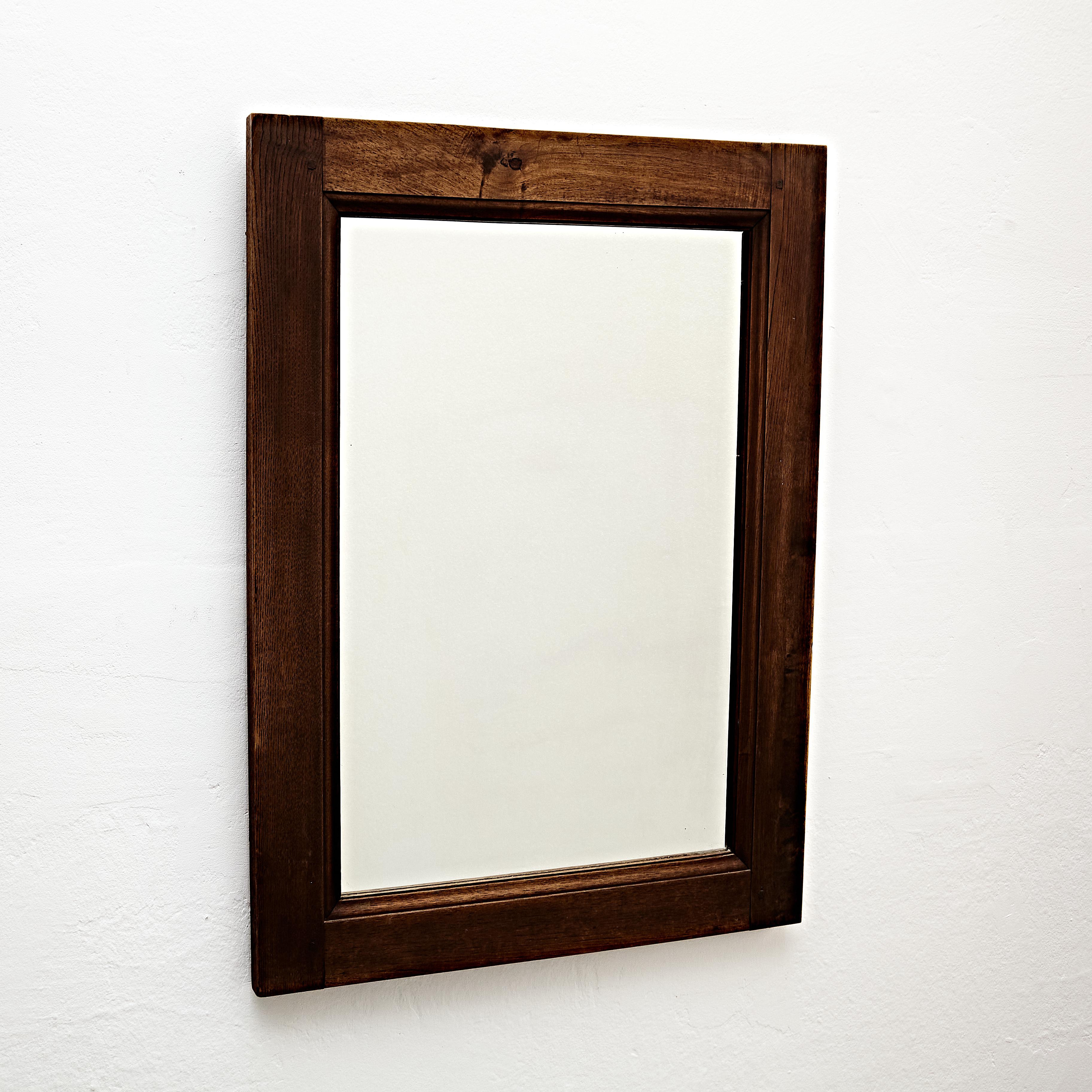 Mid-Century Modern rustic wood mirror.

Manufactured in France, circa 1960.

In original condition with minor wear consistent of age and use, preserving a beautiful patina.

Materials: 
Wood 

Dimensions: 
D 2.7 cm x W 62 cm x H 84.5