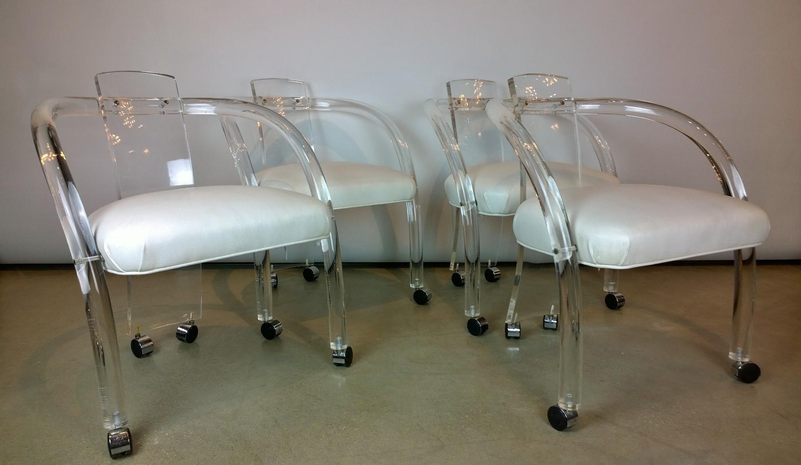 Offered is a set of four Mid-Century Modern Charles Hollis Jones style Lucite with white leatherette upholstery fabric armchairs on casters. This set is in the style of CHJ’s iconic designs. The set of arm chairs are versatile is use, design and