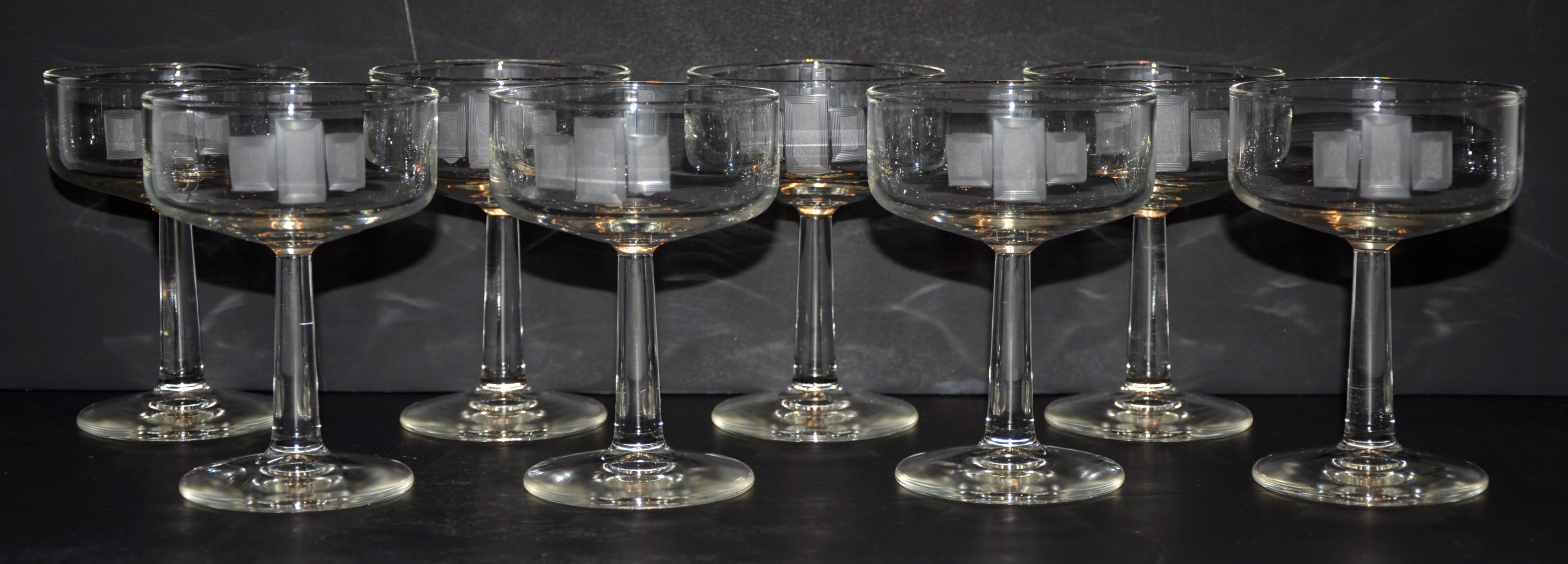 Offered is a Mid-Century Modern set of eight handmade frosted etched accent over clear glass champagne coupes. Even though this set of champagne coupe glasses were likely made in the mid-20th century, the etched design is Art Deco in style. This set