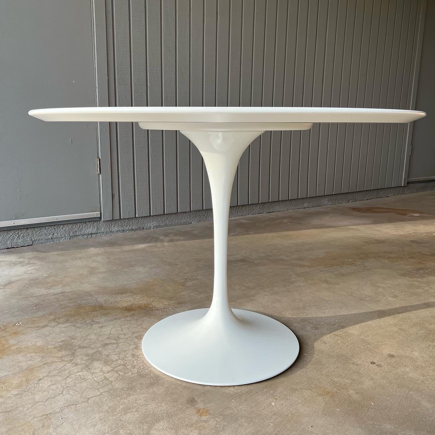 a mid century modern icon, the Saarinen dining (tulip) table was designed by Eero Saarinen in 1956 for Knoll’s Pedestal Collection. This is the 42” round version with a white base and white laminate top, and it is in excellent condition. The table