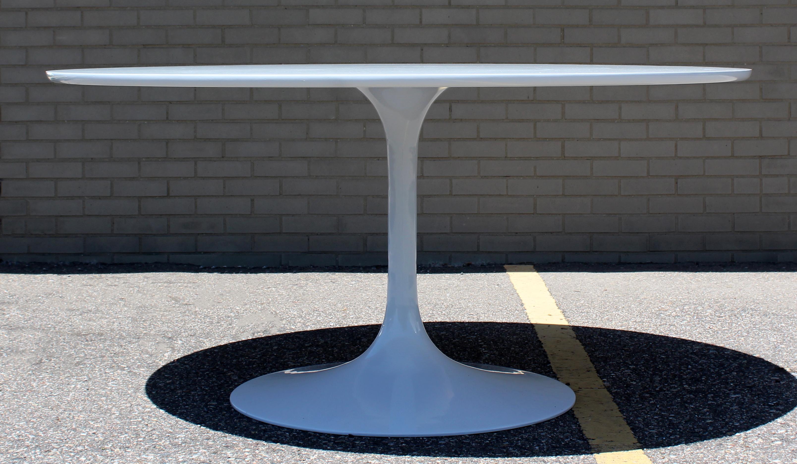 For your consideration is an Eero Saarinen style, round, Tulip dining table, by Burke, circa 1960s. In excellent condition. The dimensions are 60