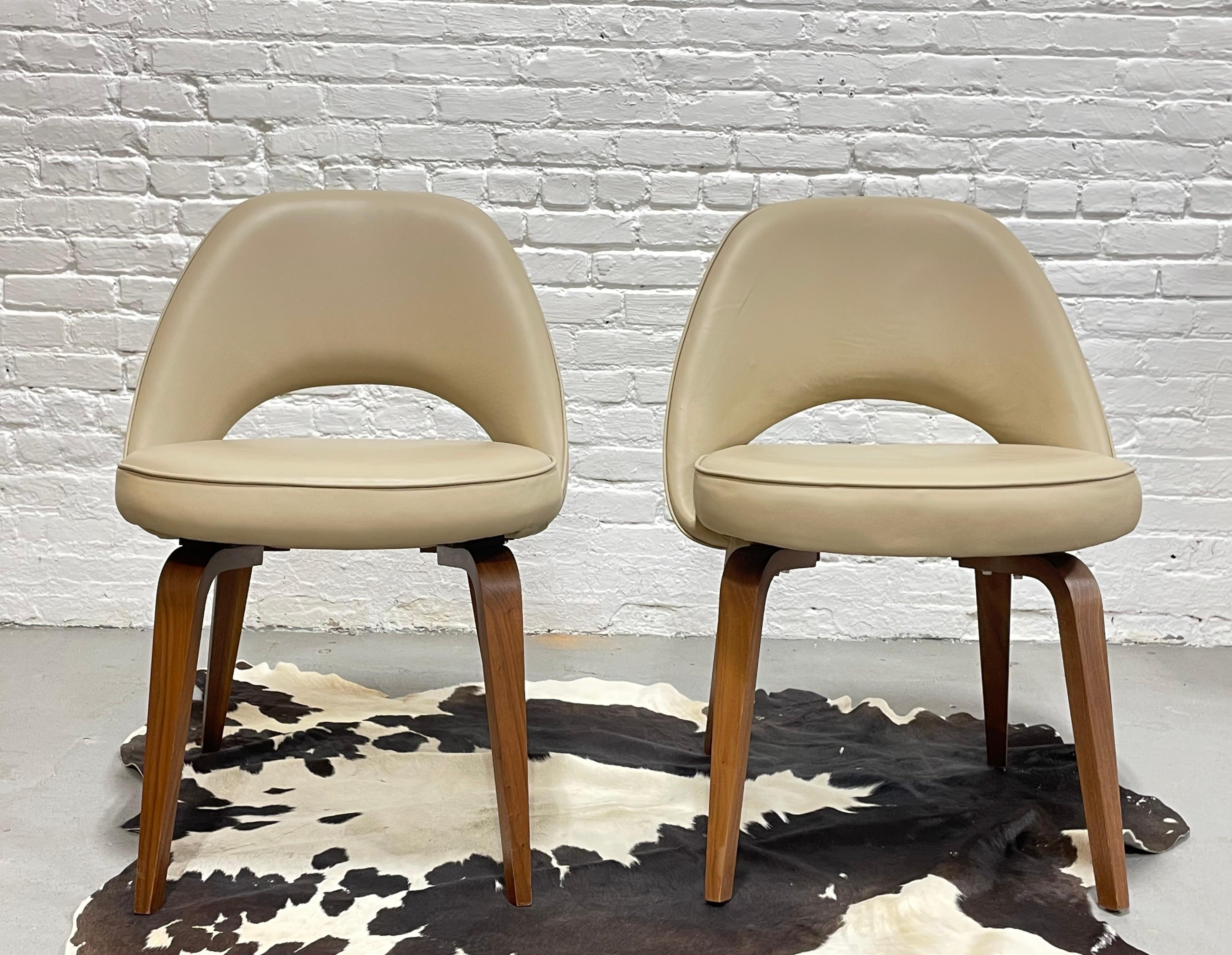 Pair of Mid-Century Modern Saarinen styled side chairs, upholstered in light biege vinyl. The bentwood legs are the highlight of this great pair and contrast beautifully with the lighter upholstery. This great set would look fabulous as side chairs