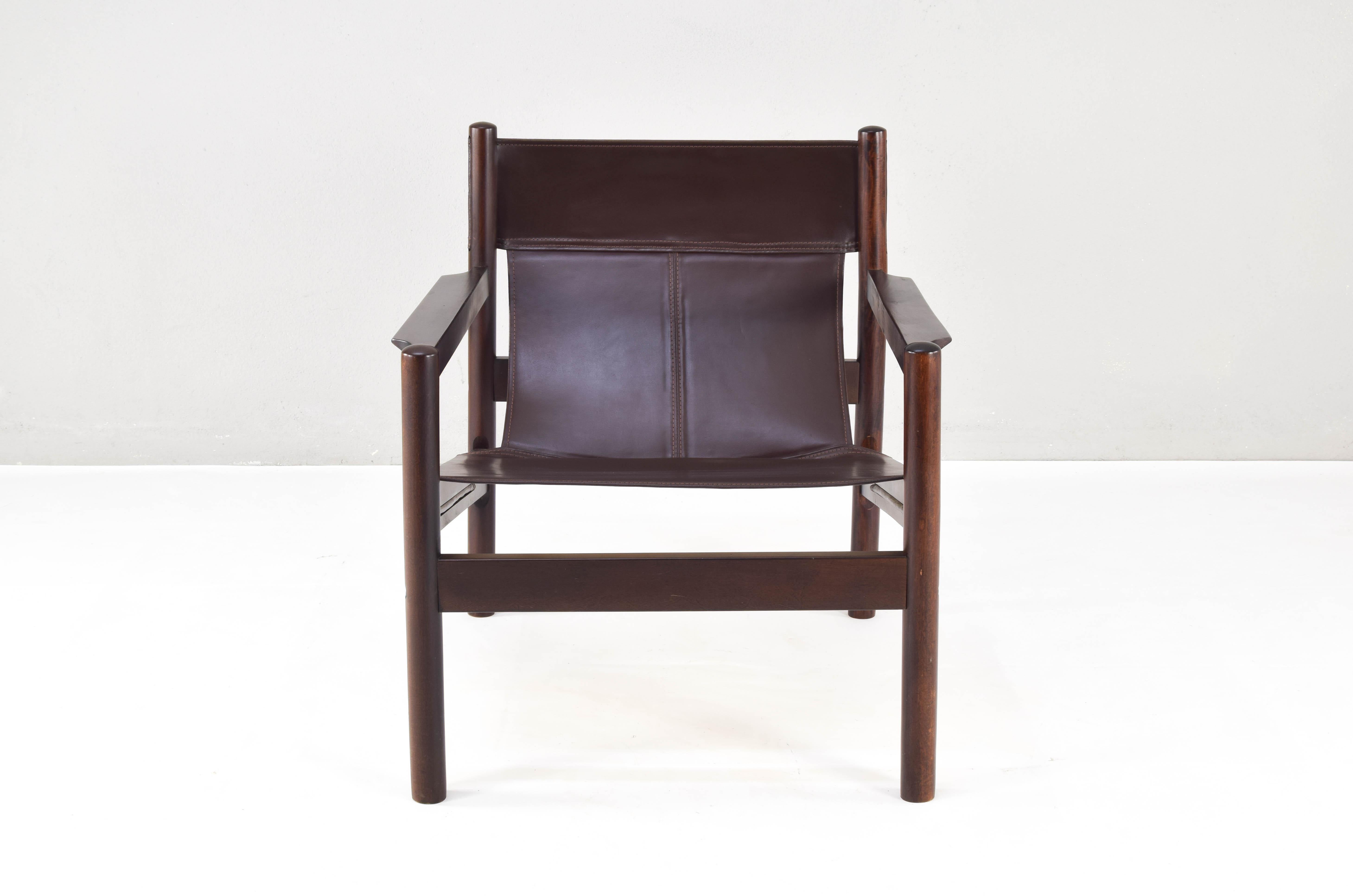 Roxinho sling mid century Safari style armchair made in Brazilian wood and leather. Designed by Michel Arnoult in the 1960s, this edition was made in Argentina. They have stitched leather upholstery and a hardwood frame.
Refined and casual