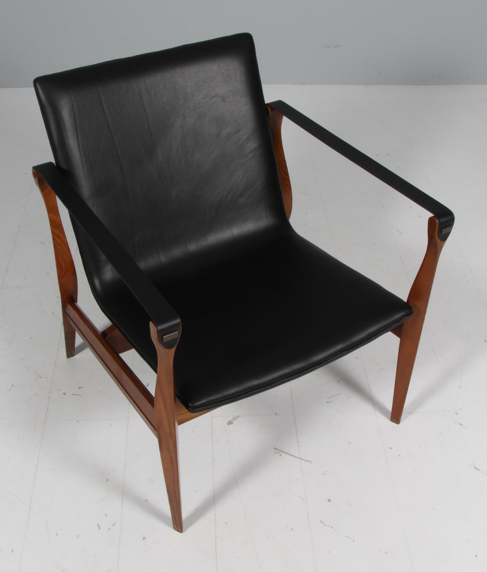 Very beautiful Safari Chair by Ebbe & Karen Clemmensen for Fritz Hansen designed in 1958 and produced in Denmark. The frame is made of ash and the seat is newly upholstered with a black full grain aniline leather. Both chairs are in a very good