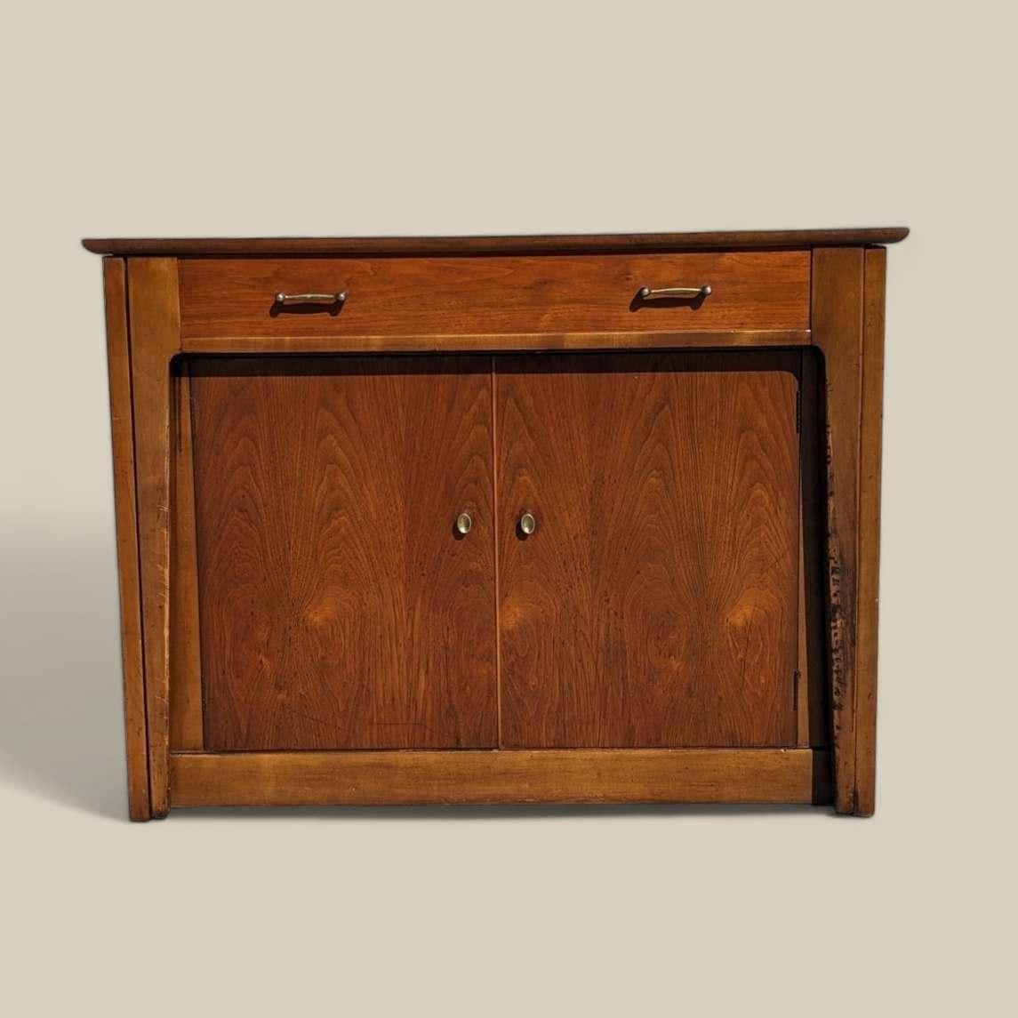 Introducing a rare and ingenious Mid-Century Modern find: the Saginaw Furniture Extendomatic Convertible Dining Table Cabinet. Crafted by Saginaw Furniture during the 1950s or 1960s, this versatile piece epitomizes the era's focus on innovative,
