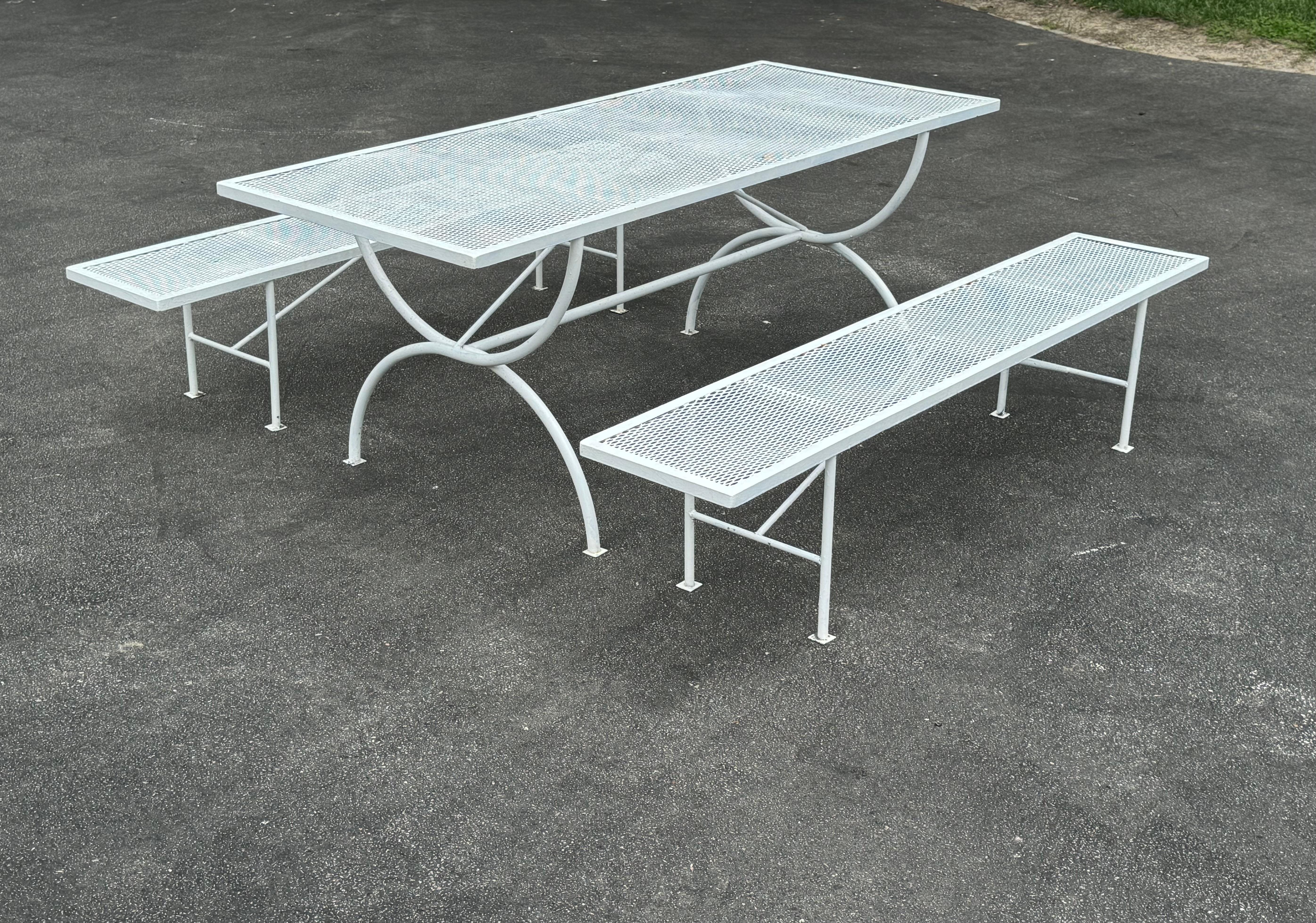 Uncommon 1960s Mid-Century Modern white painted Salterini era, wrought iron & mesh patio or garden dining set in the style of a picnic table with two benches. Versatile dining set, can also be used with regular patio chairs and use the benches