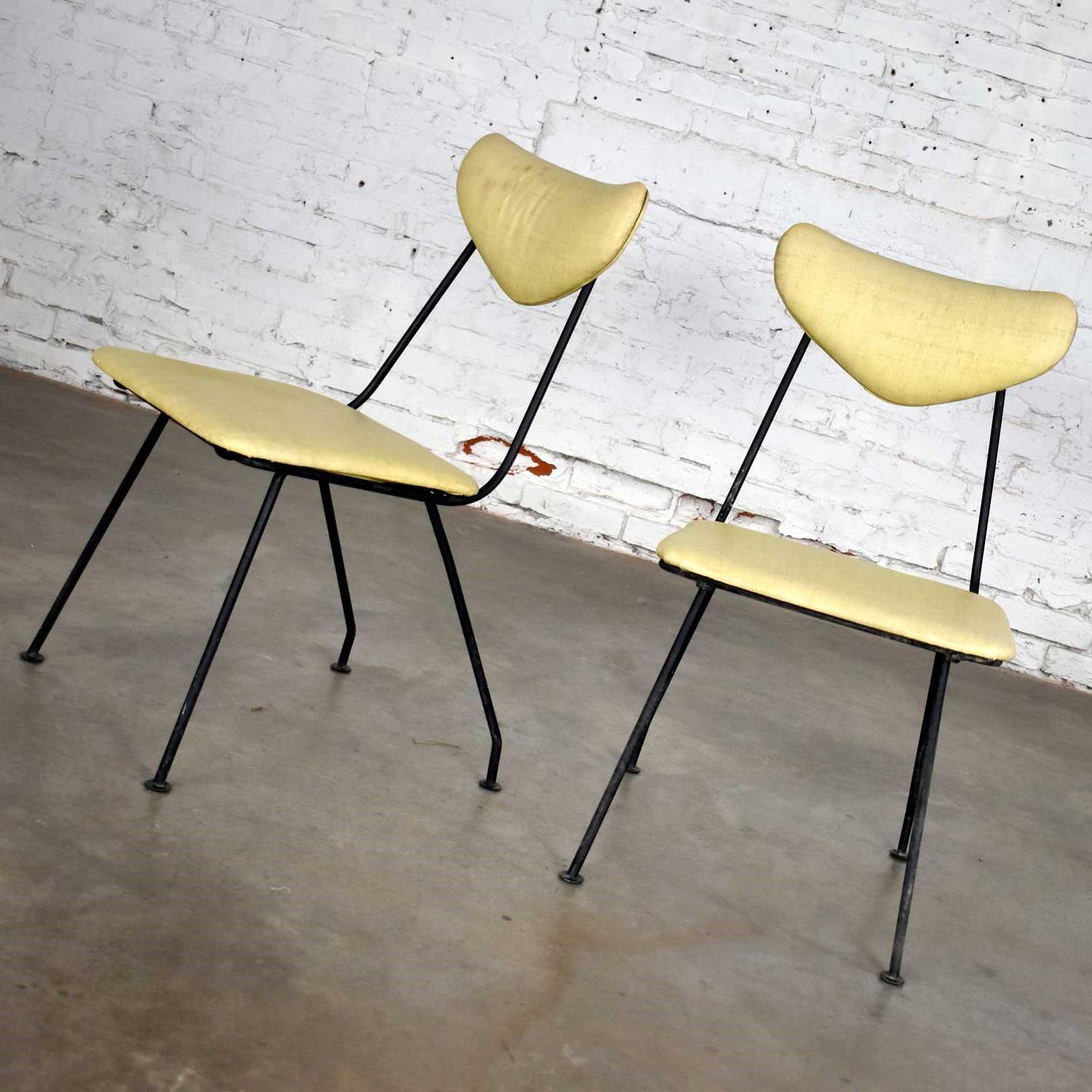 Lovely pair of Mid-Century Modern Neva-Rust patio dining chairs by Salterini comprised of their original yellow linen looking textured vinyl or faux leather fabric and black painted wrought iron frame. Beautiful condition with wear as you would