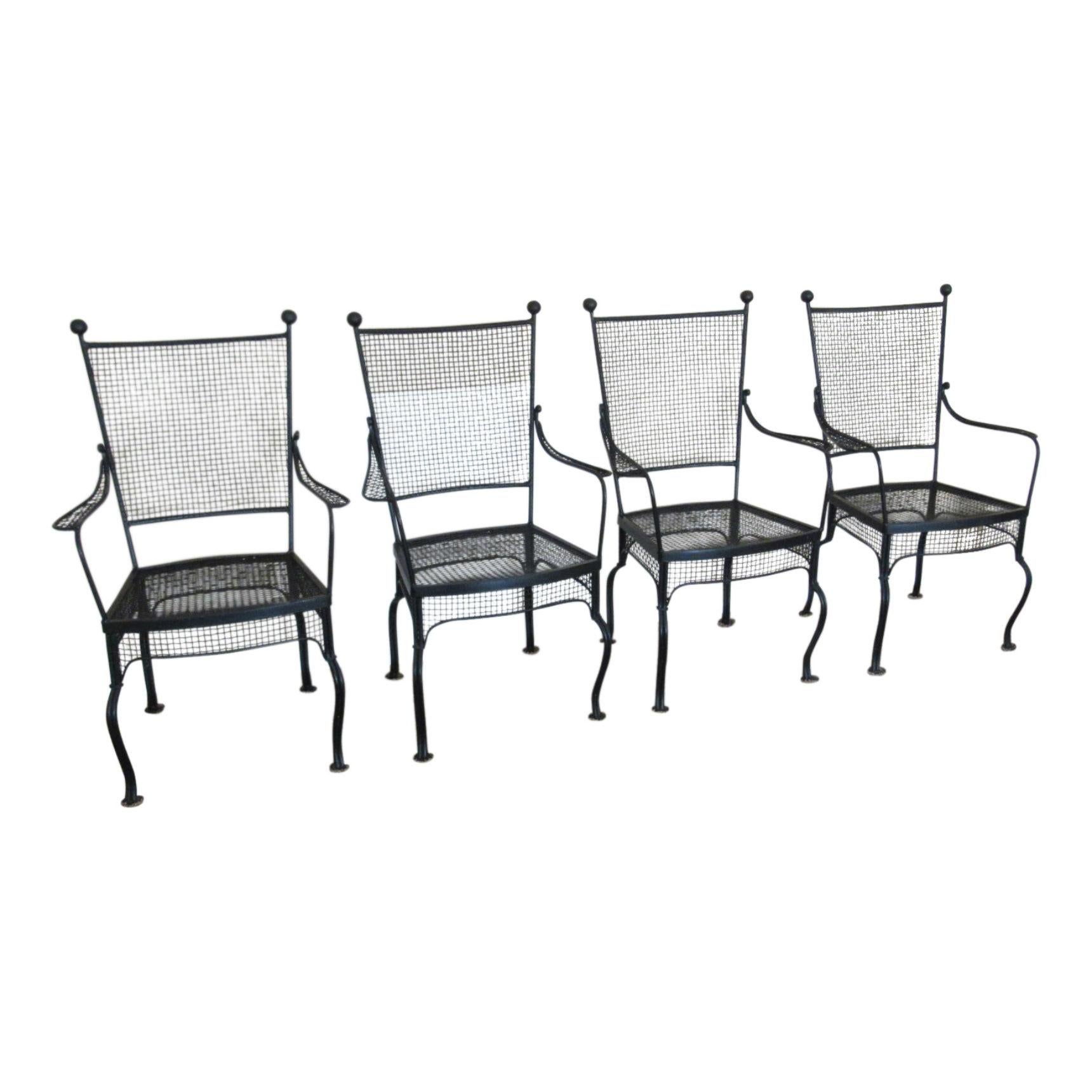 Mid-Century Modern table and four chairs design attributed to Salterini, Italian, circa 1950s. Four high back chairs composed of wrought iron with matching wrought iron patio dining table. In very good original condition.

Measures: Table 41.5”