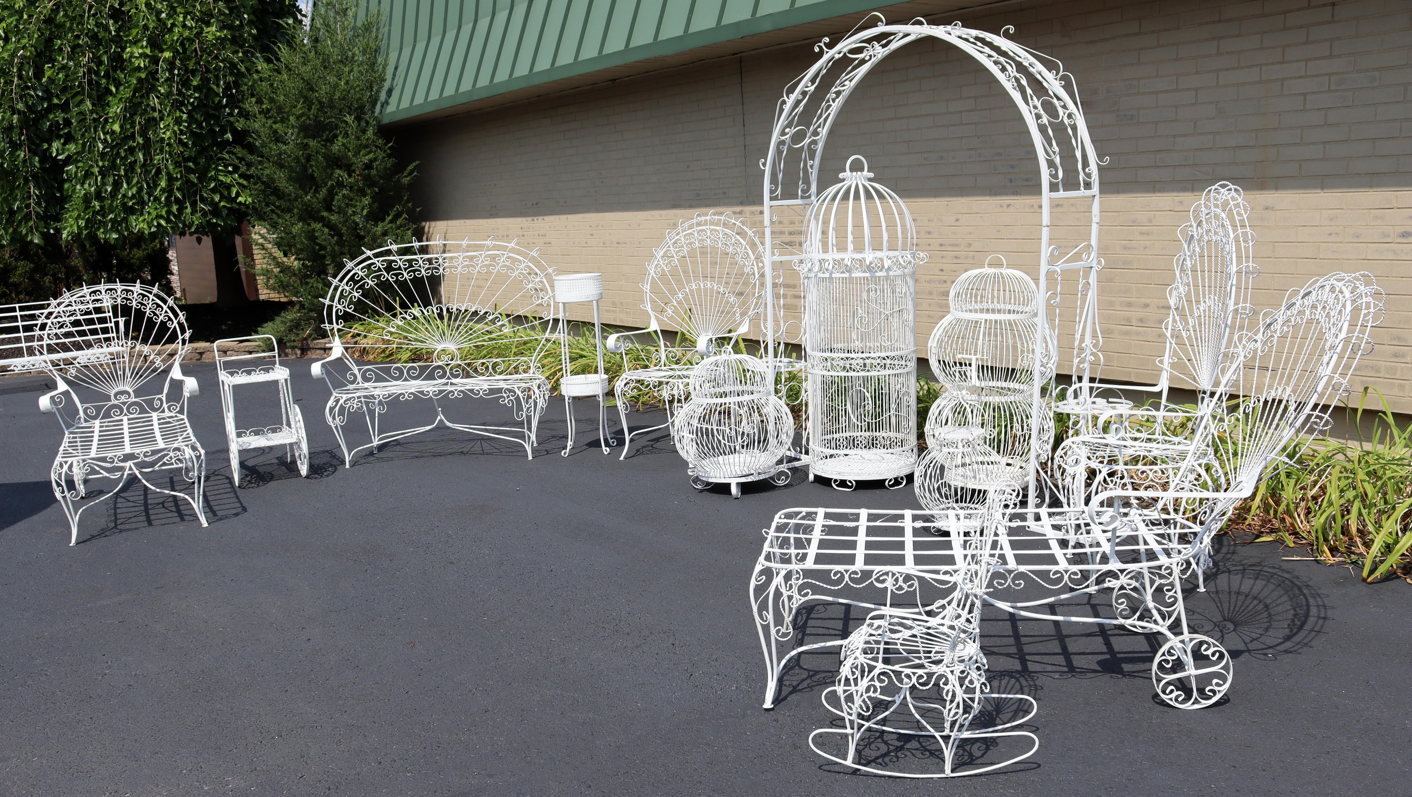 For your consideration is a stupendous, outdoor, twisted wrought iron patio set; including a trellis, pair of chaises, set of four birdcages, a planter, a child's rocker, a settee, a small bar cart and pair of peacock chairs, by Salterini, circa the