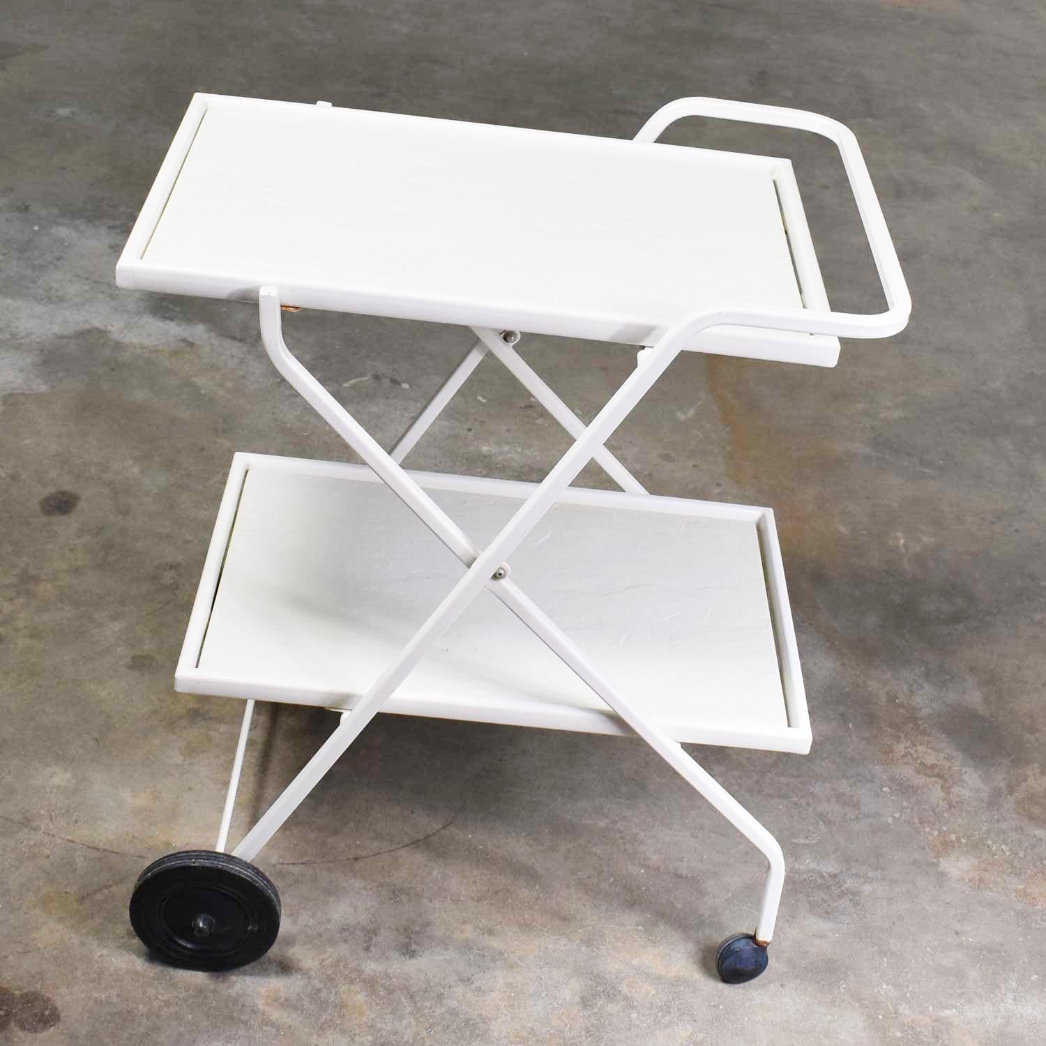 Handsome Mid-Century Modern patio white fiberglass and enameled steel tube two-tiered tea cart, bar cart, or drink cart by Samsonite. It is in fabulous vintage condition with no outstanding flaws we have detected. Please see photos, circa