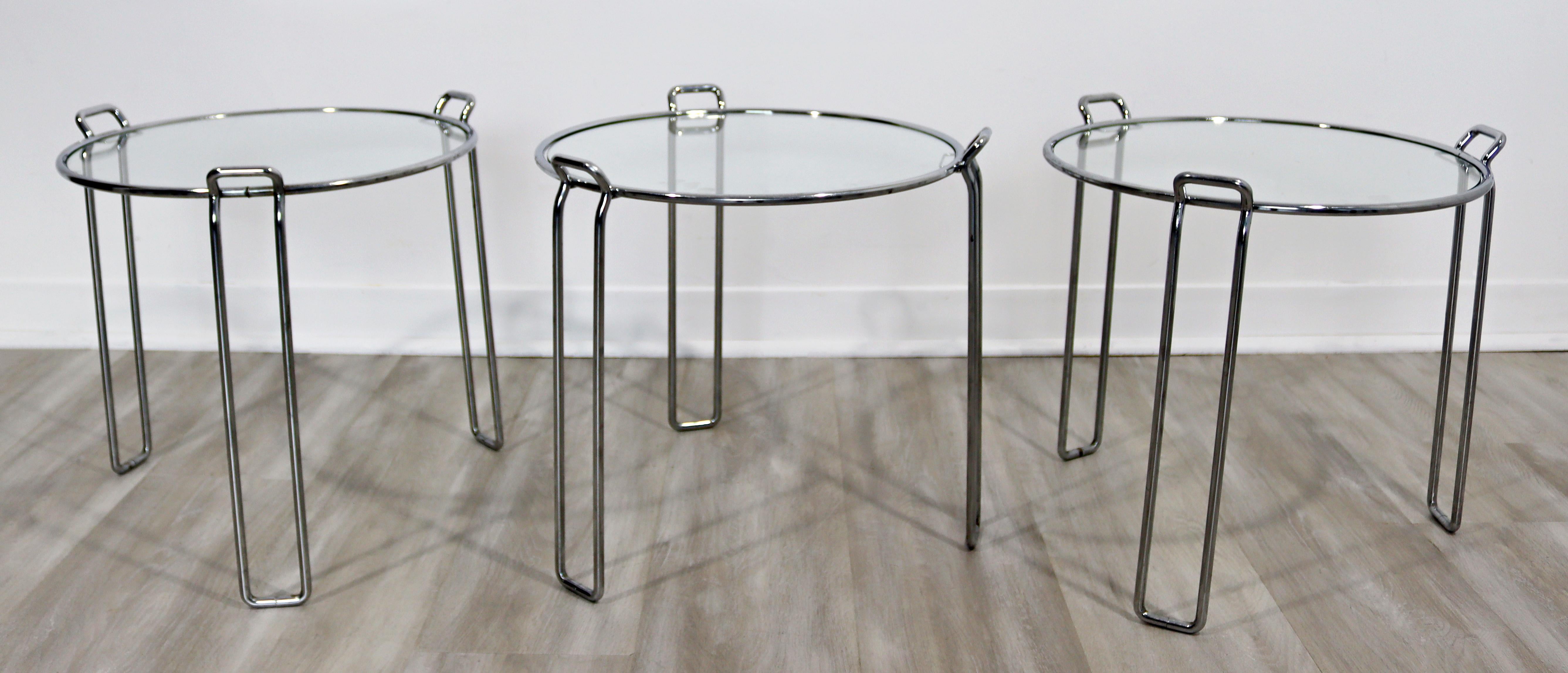 For your consideration is a fabulous set of three stacked nesting tables, made of chrome and with glass tops, by Saporiti, made in Italy, circa the 1960s. In excellent vintage condition, with one tiny nick in a glass top. The dimensions of each are