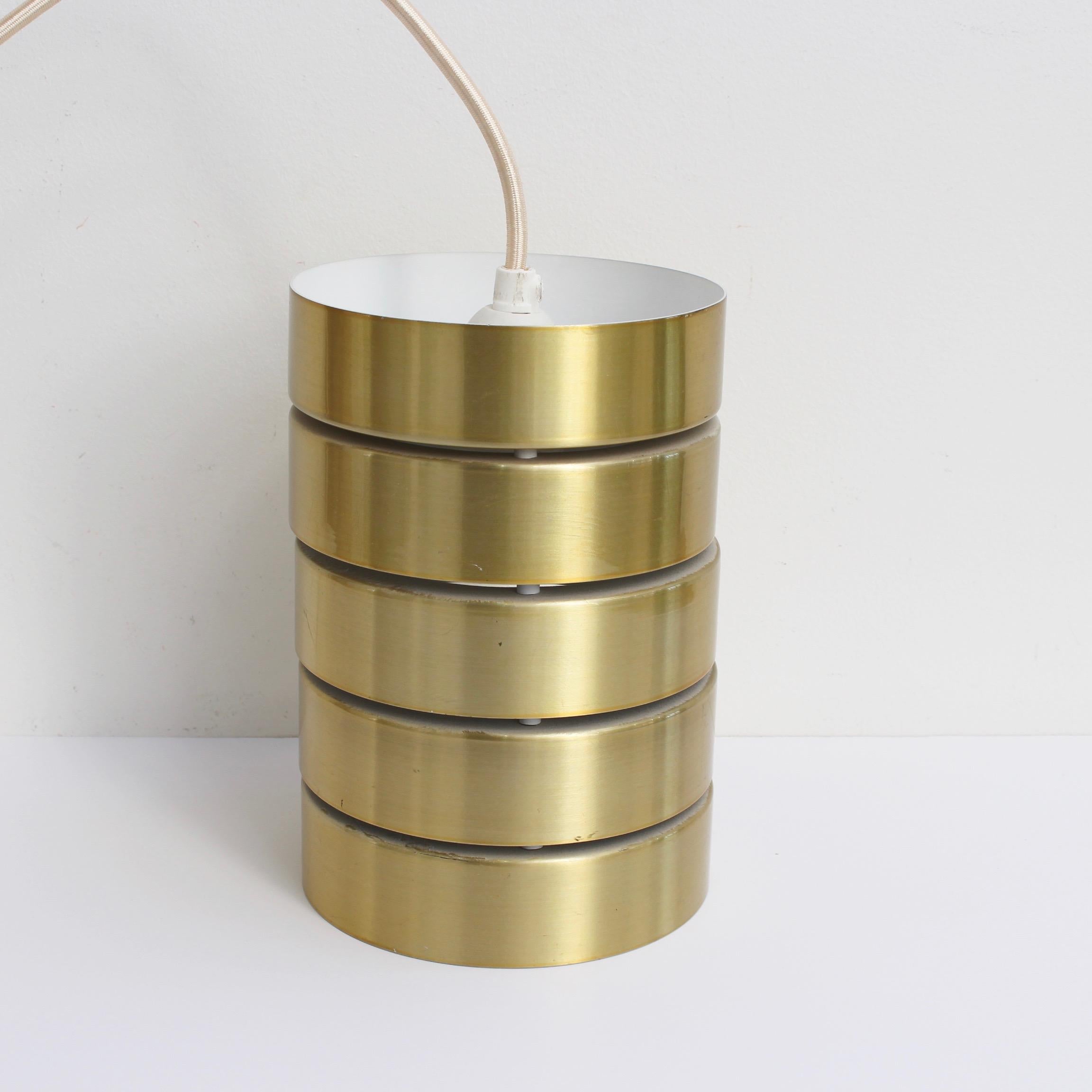 Mid-Century Modern Scandinavian ceiling light fixture (circa 1960s). Layered, polished brass-plated rings form the body and structure of the piece. Quintessentially Modern Scandinavian look completely rewired to modern specifications. In overall