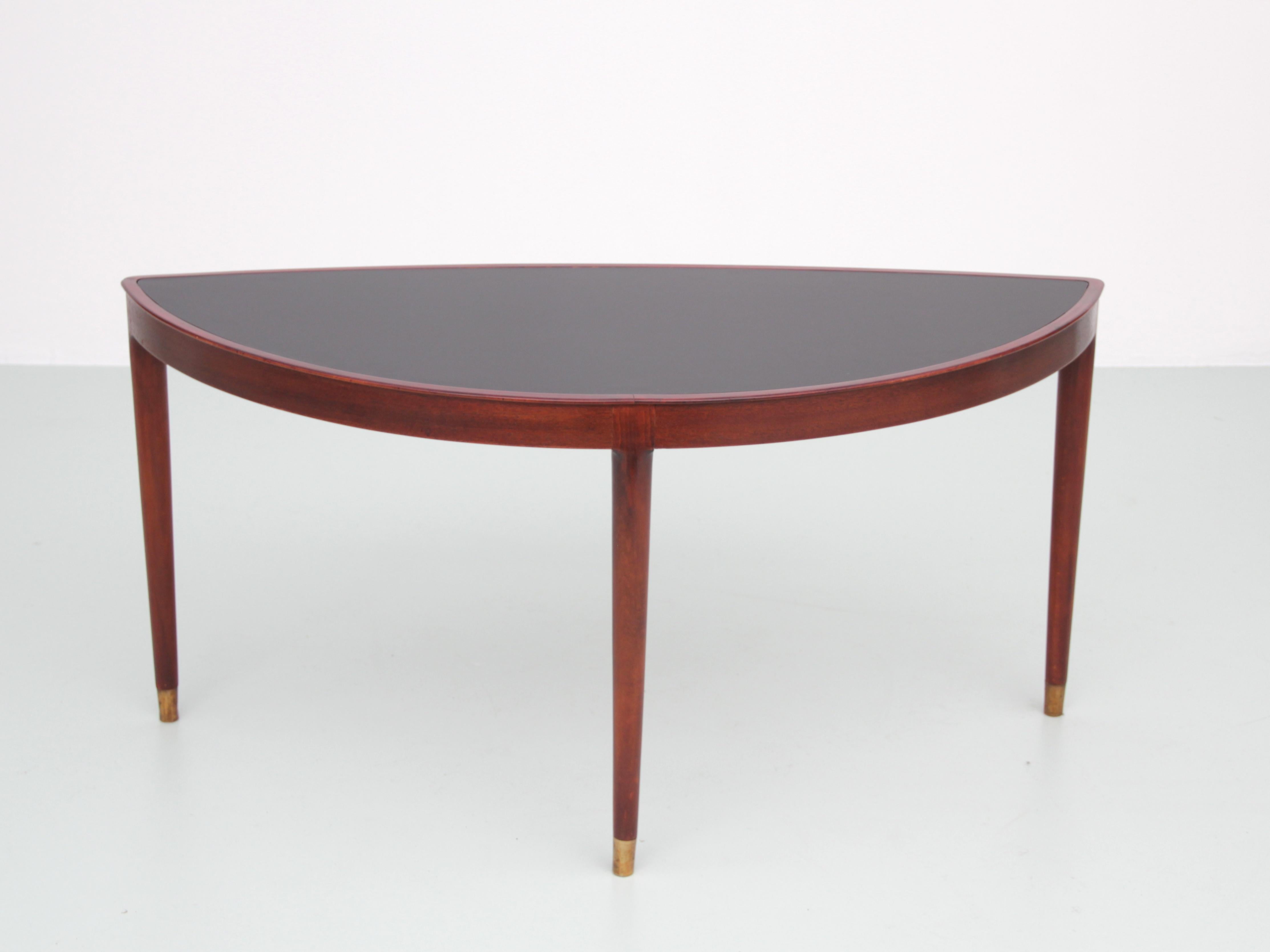 Mid-Century Modern Scandinavian coffee table or side table. Mahogany frame. Black melamine top, restored. Brass legs. Swedish work.