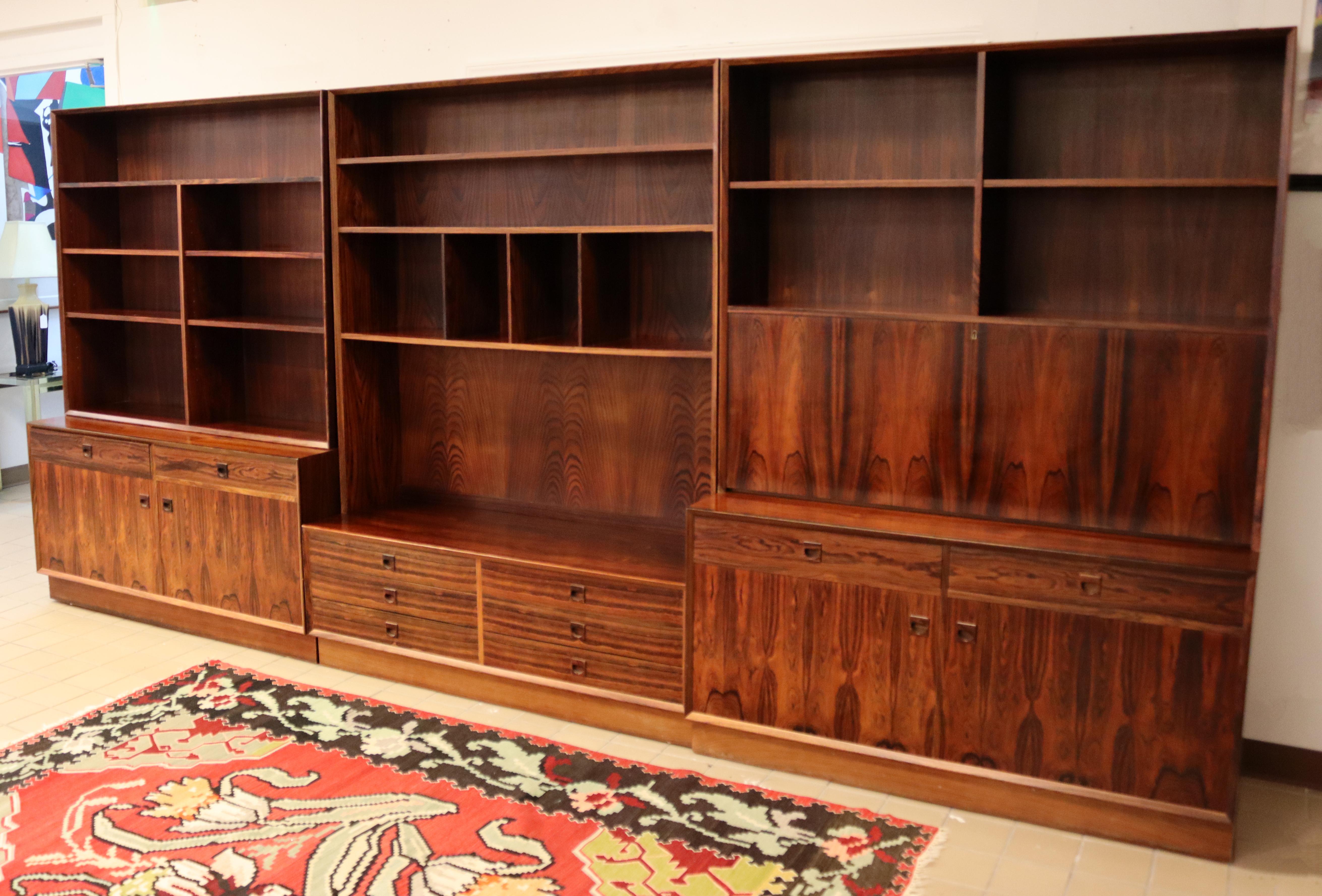 For your consideration is a ravishing, rosewood wall unit, made in Denmark, circa the 1970s. Includes drop down desk with key. In excellent condition. Dimensions: 158