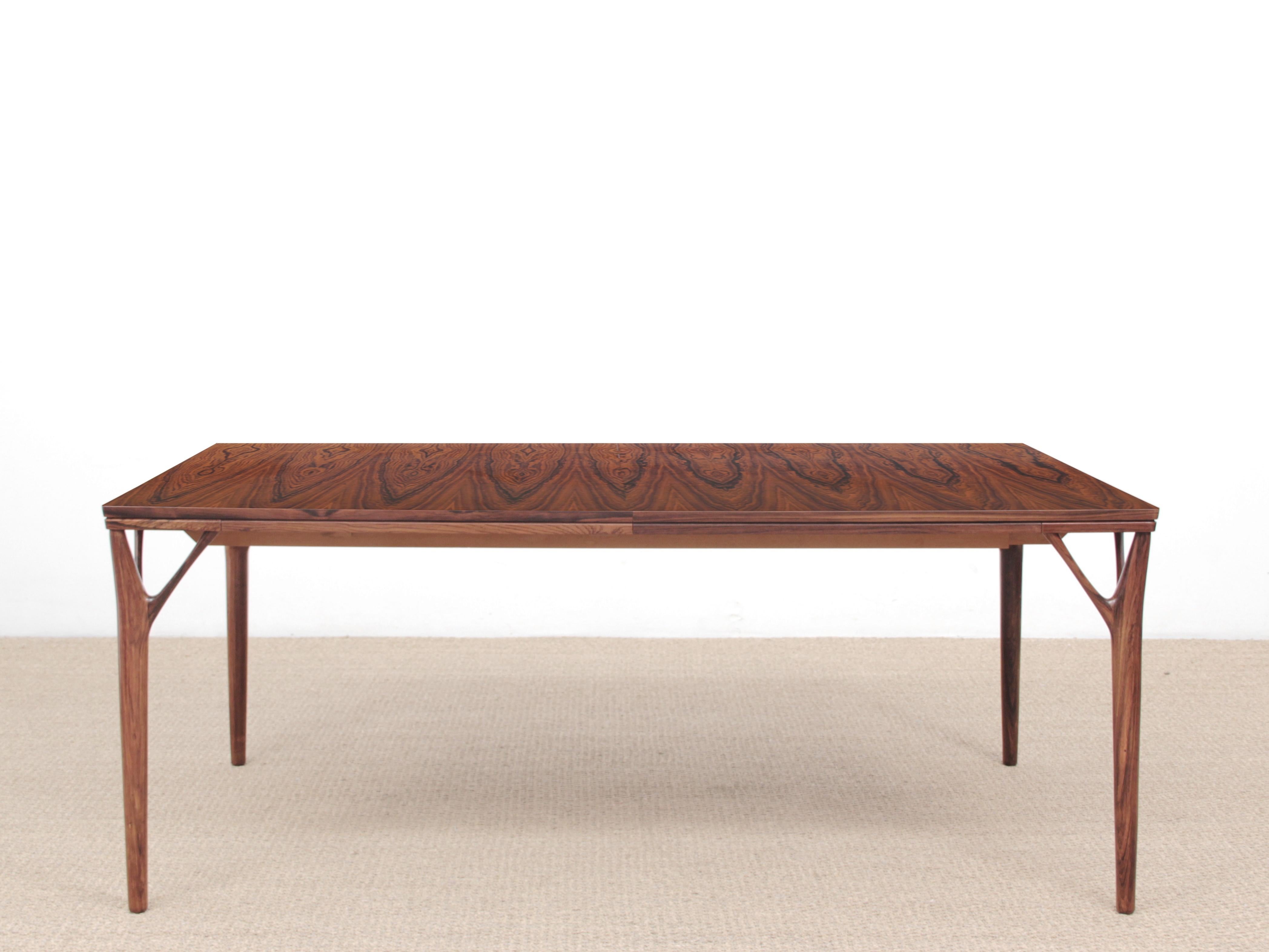 Mid-Century Modern Scandinavian dining table in rosewood designed by Helge Vestergaard Jensen for Søren Horn, in 1970. 8-12 seats, up-and-over extension flap, hidden underneath the tabletop.