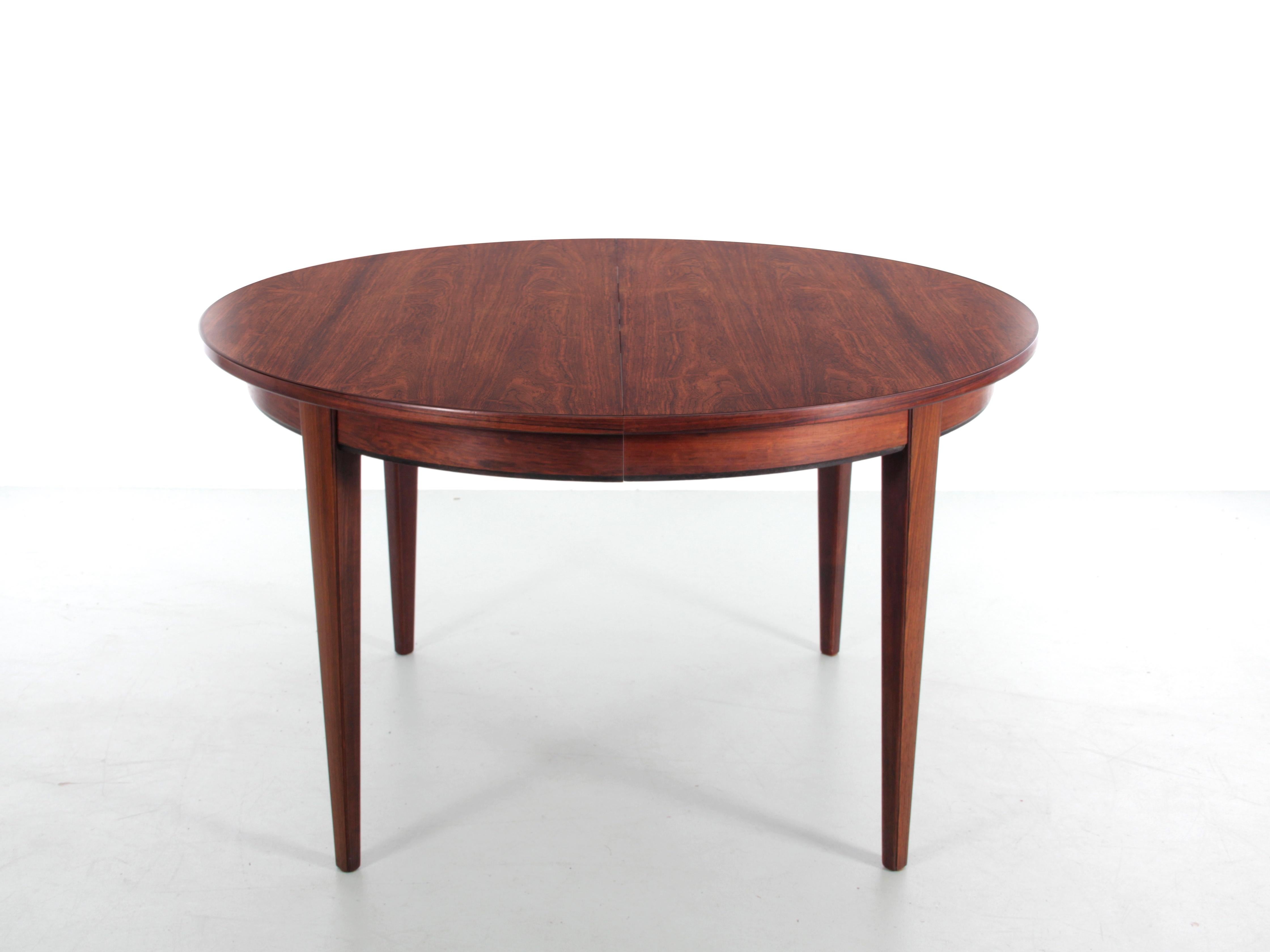 Mid-Century Modern scandinavian dining table in rosewood with 3 extra leaves.