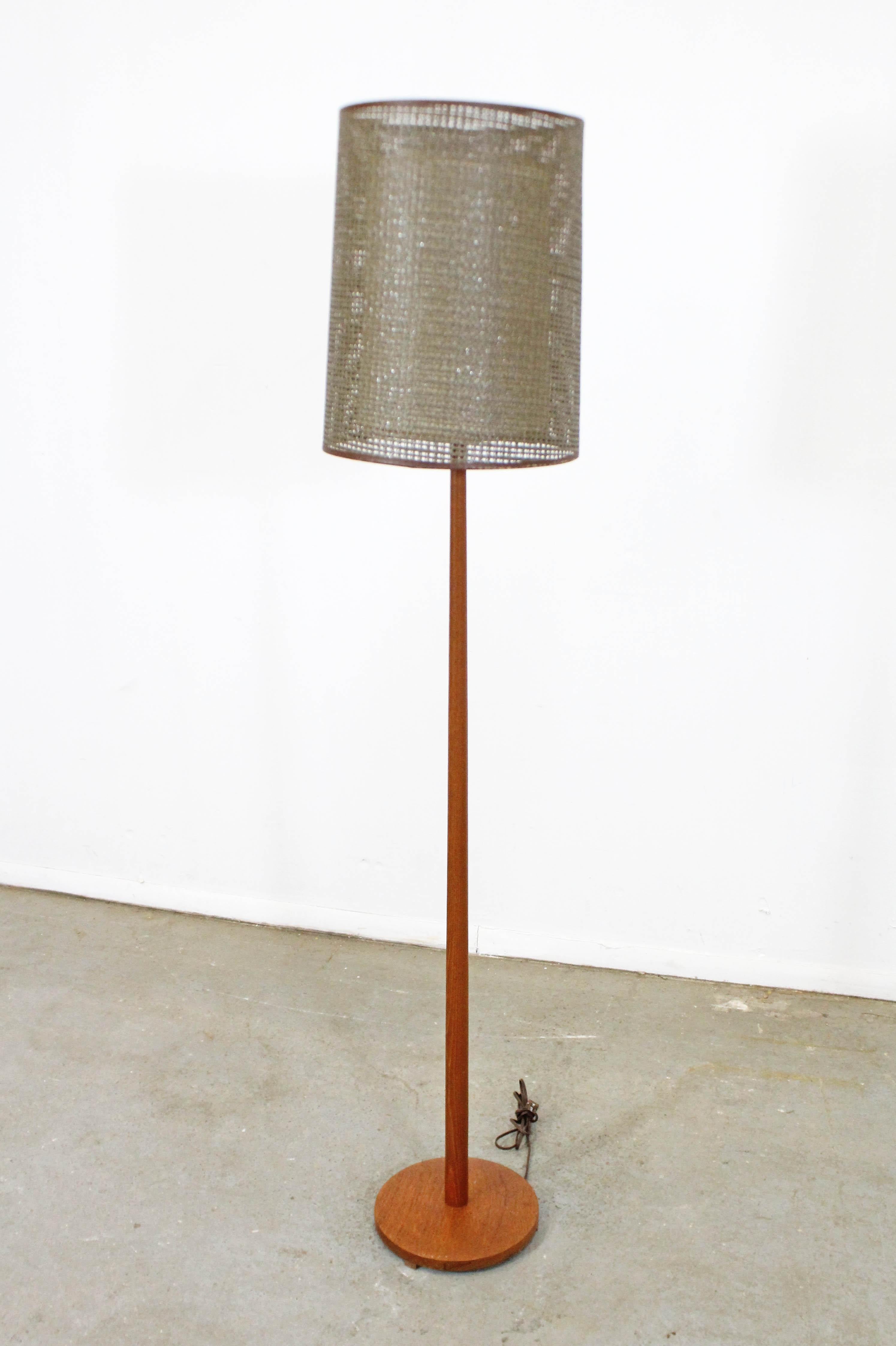 Offered is a vintage Danish modern teak floor lamp with a double-shade made by George Kovacs for Underwriters Laboratories, Inc., circa 1960. In good, working condition (has been tested). Shows minor surface scratches/wear on wood and some edge wear