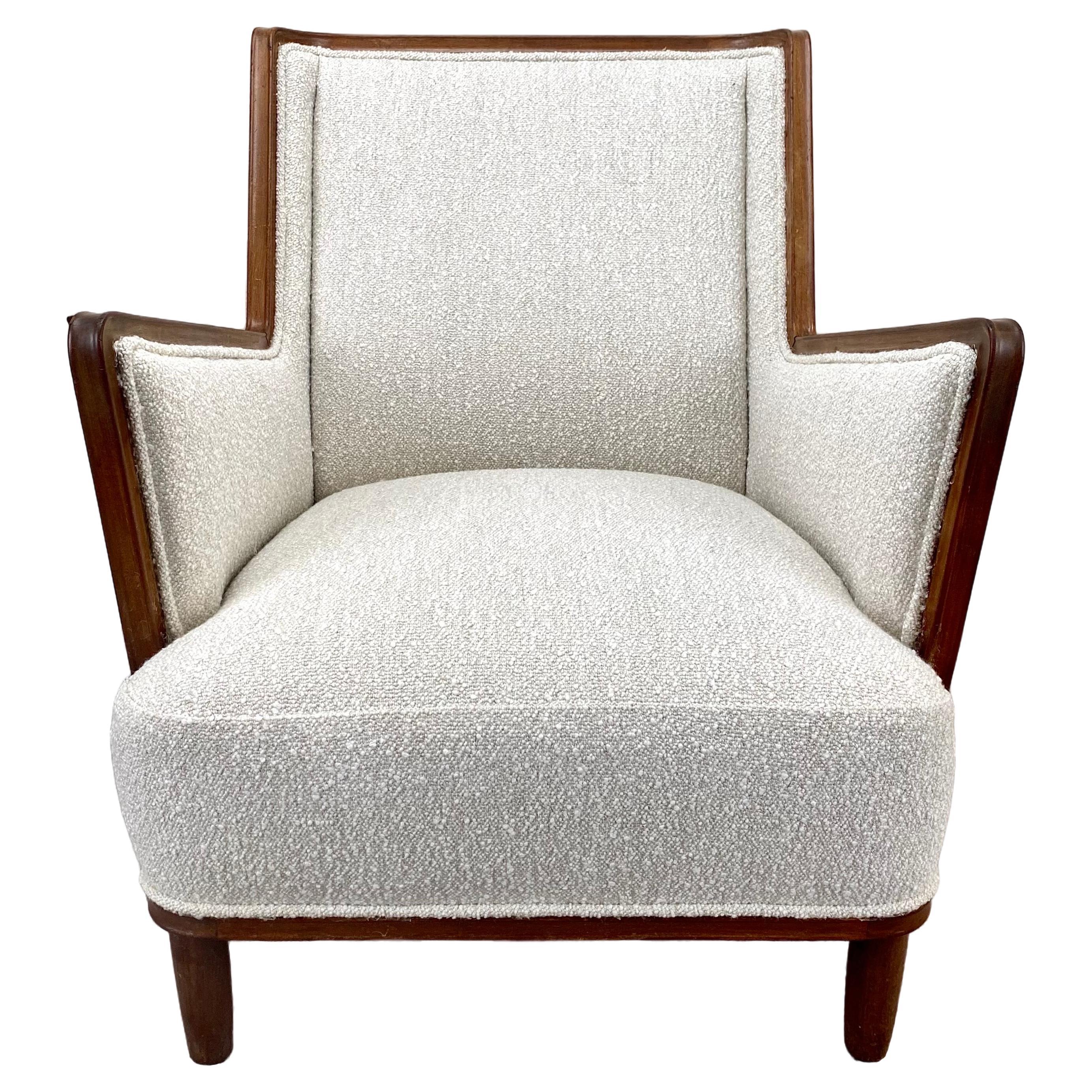 A Mid Century Modern Finish lounge chair crafted  by a masterful cabinetmaker. This resplendent piece of furniture boasts a mahogany frame, painstakingly hand-carved to evoke a sense of enduring sophistication. Notably distinguished by its artfully