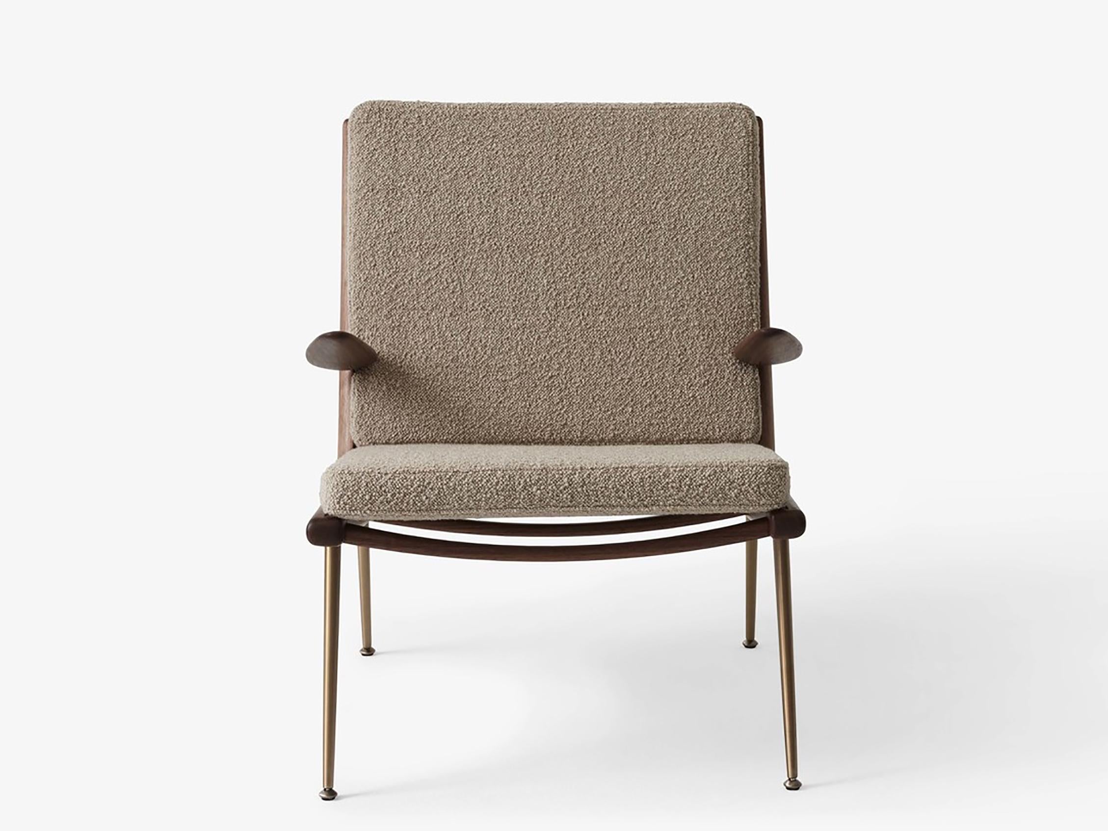 Boomerang lounge chair HM1 by Hvidt and Mølgaard. New edition. Debuted in 1956, the lounge chair by duo Hvidt & Mølgaard has a no-frills, streamlined form. From the hand-polished wooden frame, to its slender brass legs, the Boomerang endures as a