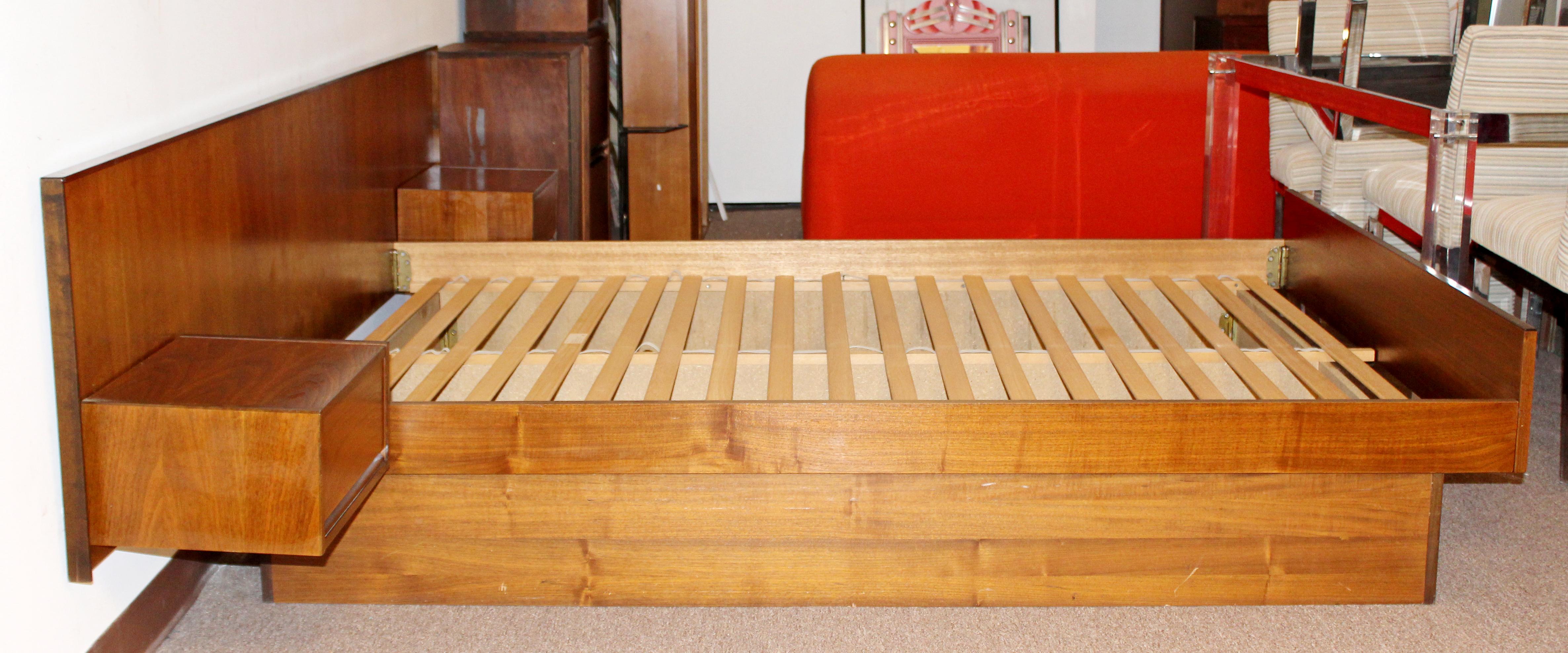 For your consideration is a magnificent, walnut wood platform bed frame, for a Queen size, with attached floating drawers on the headboard, made in Denmark, circa 1960s. In excellent vintage condition. The dimensions of the headboard are 101