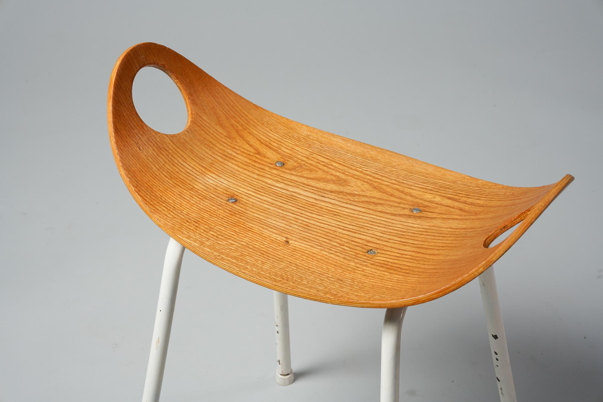 Mid-Century Modern Scandinavian stool designed by Olof Kettunen for J.Merivaara Oy, 1950s, bend plywood, metal frame, beautiful Minimalist design, good original condition, minor wear consistent with age and use. 

Ola Kettunen, better known as