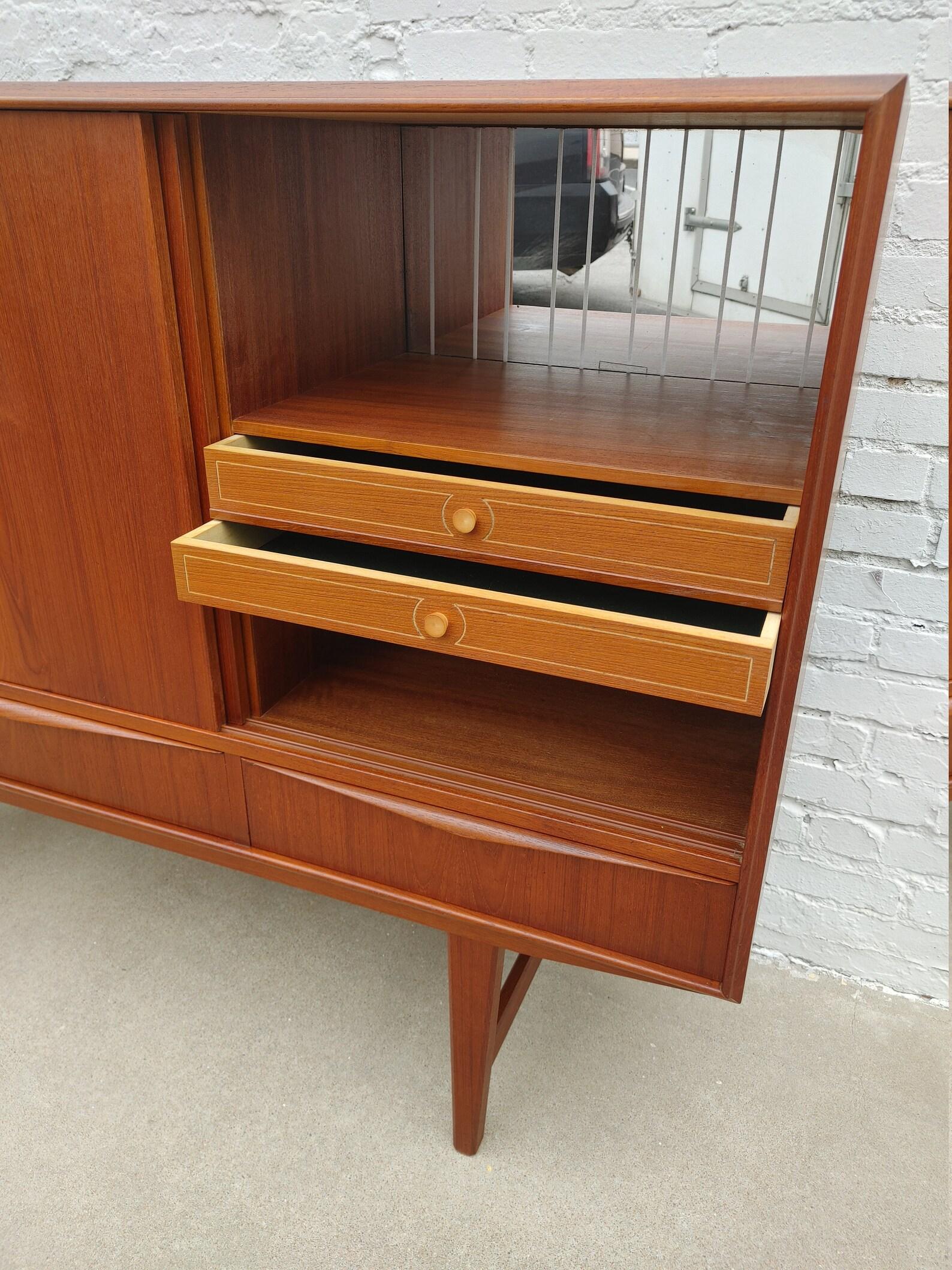 Mid Century Modern Scandinavian Teak Cabinet

Above average vintage condition and structurally sound. Has some expected slight finish wear and scratching.

Additional information:
Materials: Teak
Vintage from the 1960s
Dimensions: 65  W x 17.25  D x
