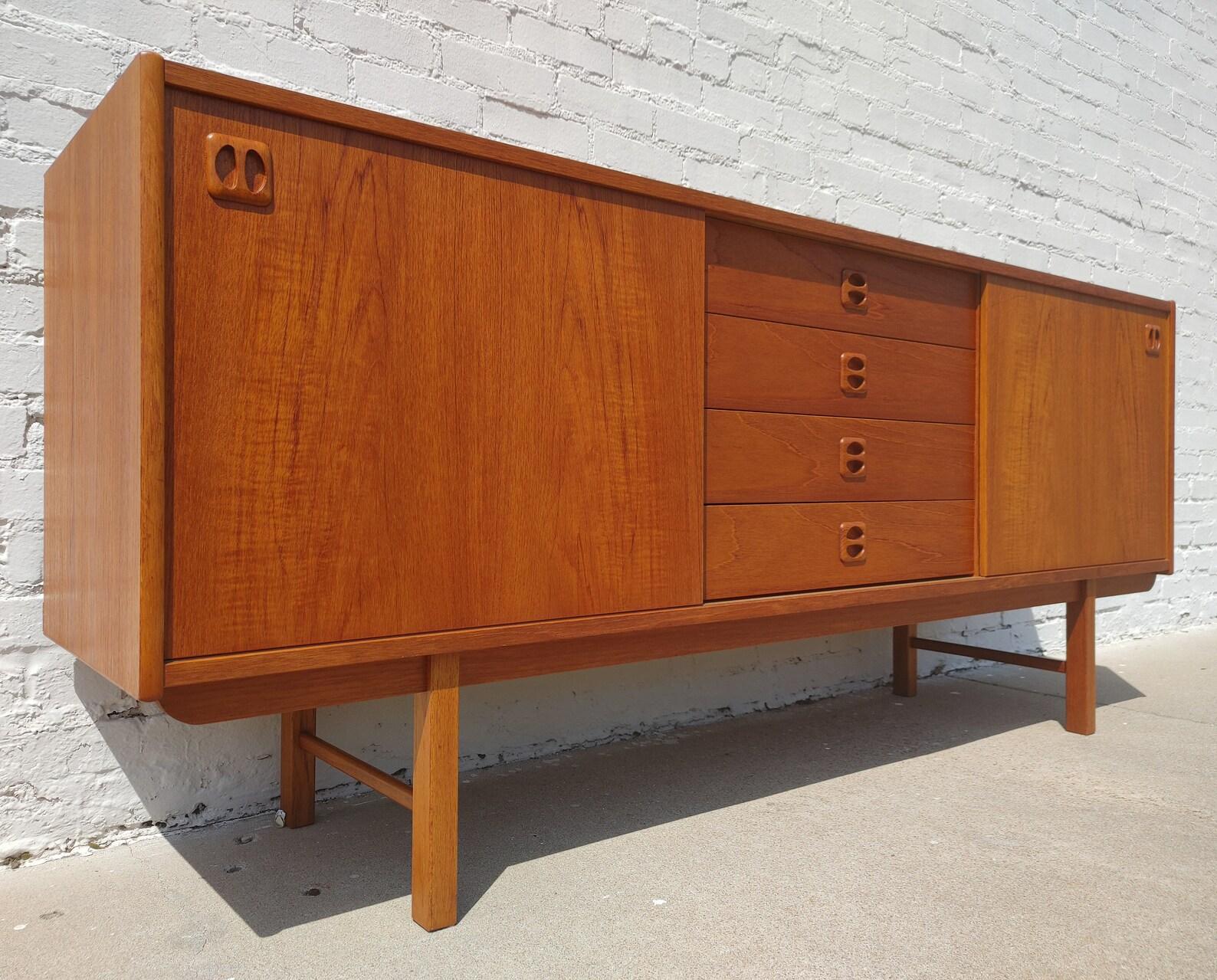 Mid Century Modern Scandinavian Teak Credenza

Above average vintage condition and structurally sound. Has some expected slight finish wear and scratching.

Additional information:
Materials: Teak
Vintage from the 1960s
Dimensions: 72  W x 16.5  D x