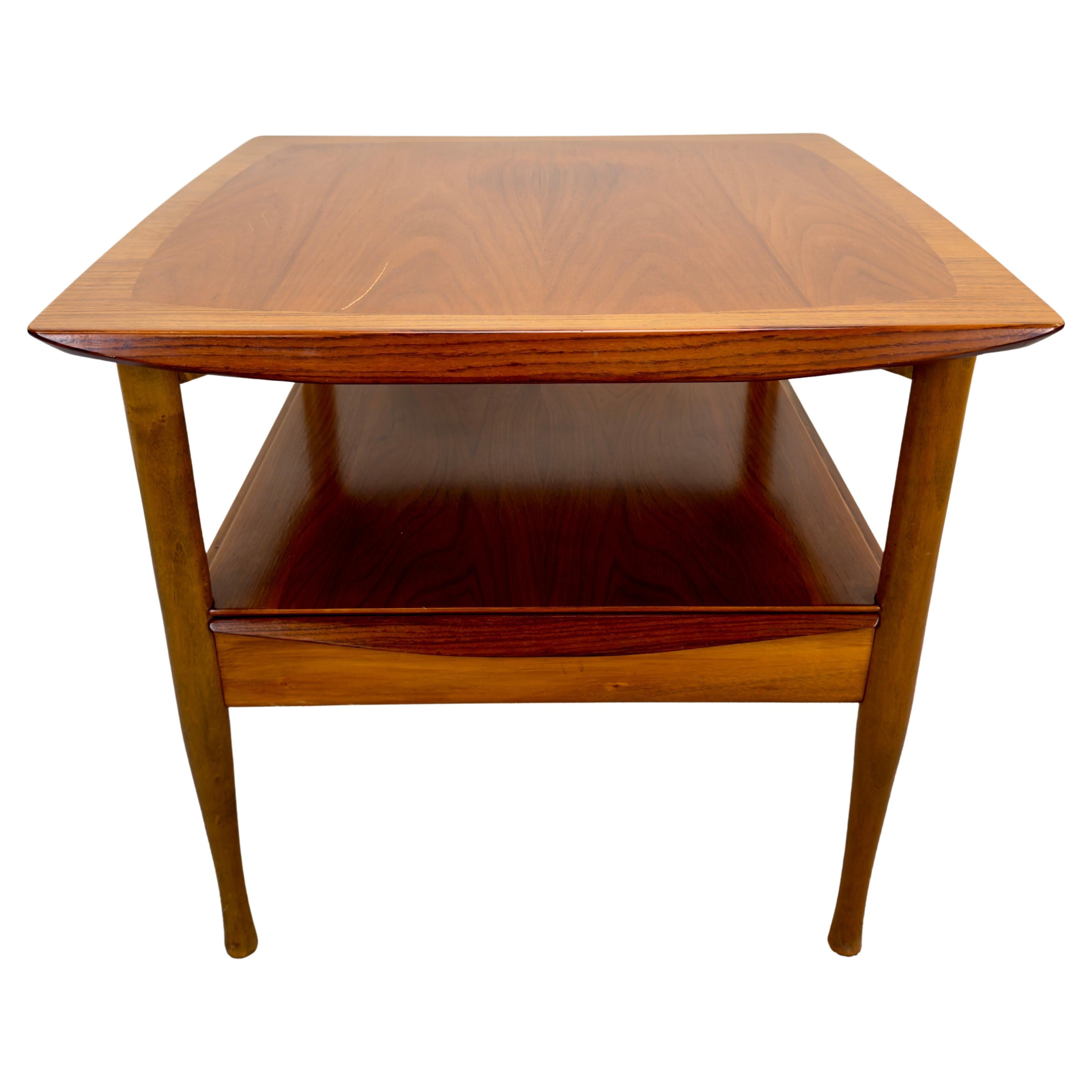 A timeless  Mid Century Modern design solid teak side or end table, crafted in the manner of the iconic Finn Juhl, seamlessly blends functionality with aesthetic grace. The distinctive features include a floating top and a thoughtfully incorporated