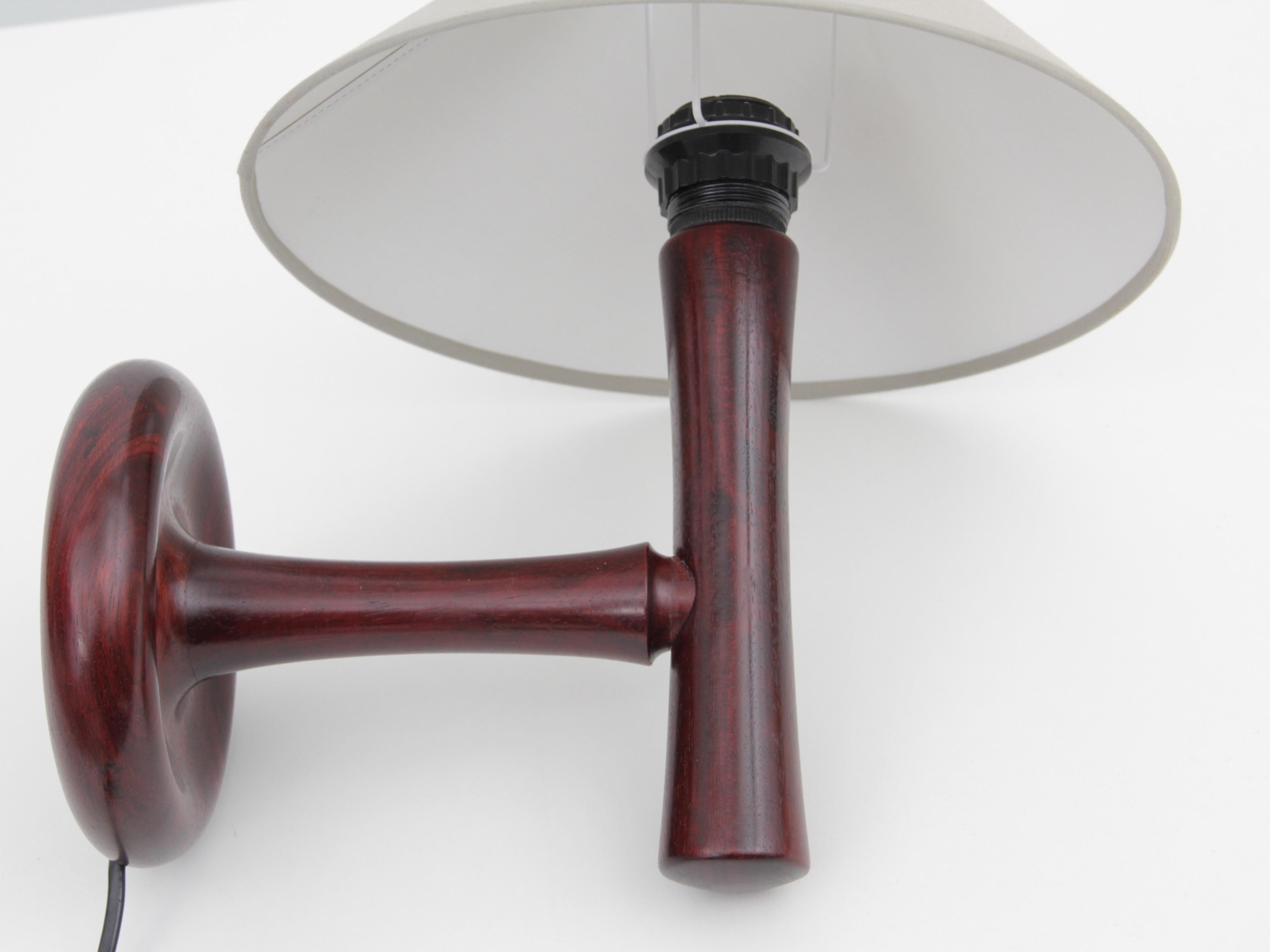 Mid-Century Modern Scandinavian wall lamp in rosewood. Sold with shade.