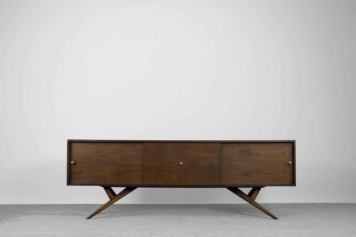 This high sideboard was made in Denmark during the 1960s. This piece was finished in a shade of wood, where between the main color you can also see caramel-colored threads. Additional aesthetic values have been obtained due to transient graining.