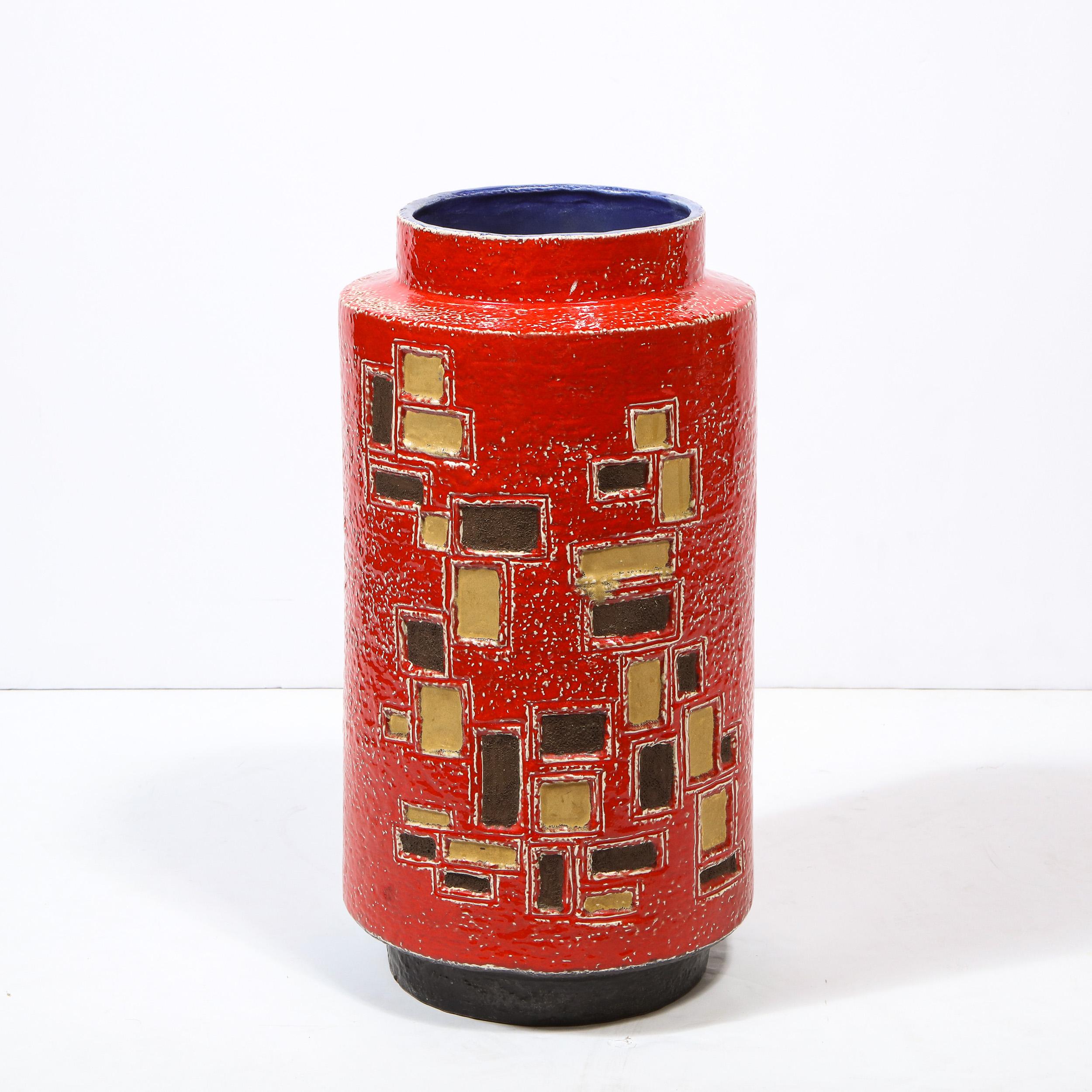 This refined Mid-Century Modern umbrella stand was realized in Italy, circa 1960. It features a cylindrical body with an inset circular mouth with scarlet red handpainted exterior replete with gold and java hued rectilinear detailing, as well as a