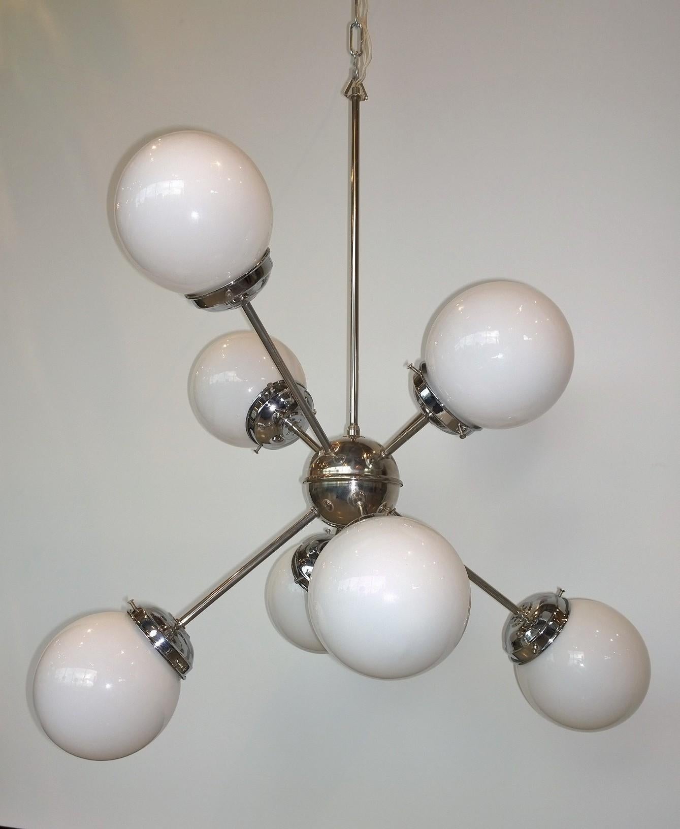 Offered is a Mid-Century Modern Italian Gaetano Sciolari eight-arm and torchère with large white globes and chrome plate 